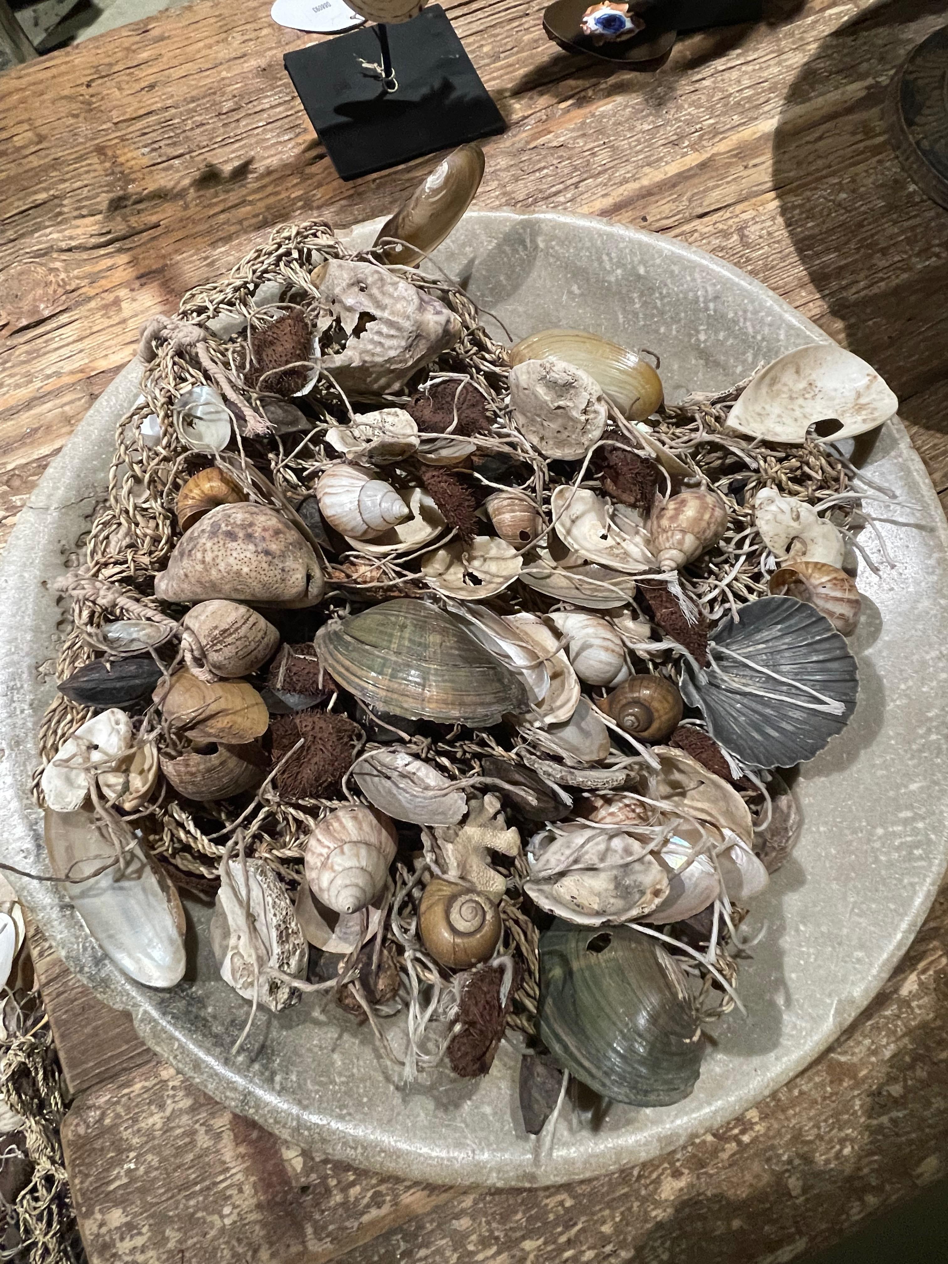 Contemporary Indonesian purse made of a multitude of different shells.
All connected by natural twine.
Very decorative placed in a bowl.
