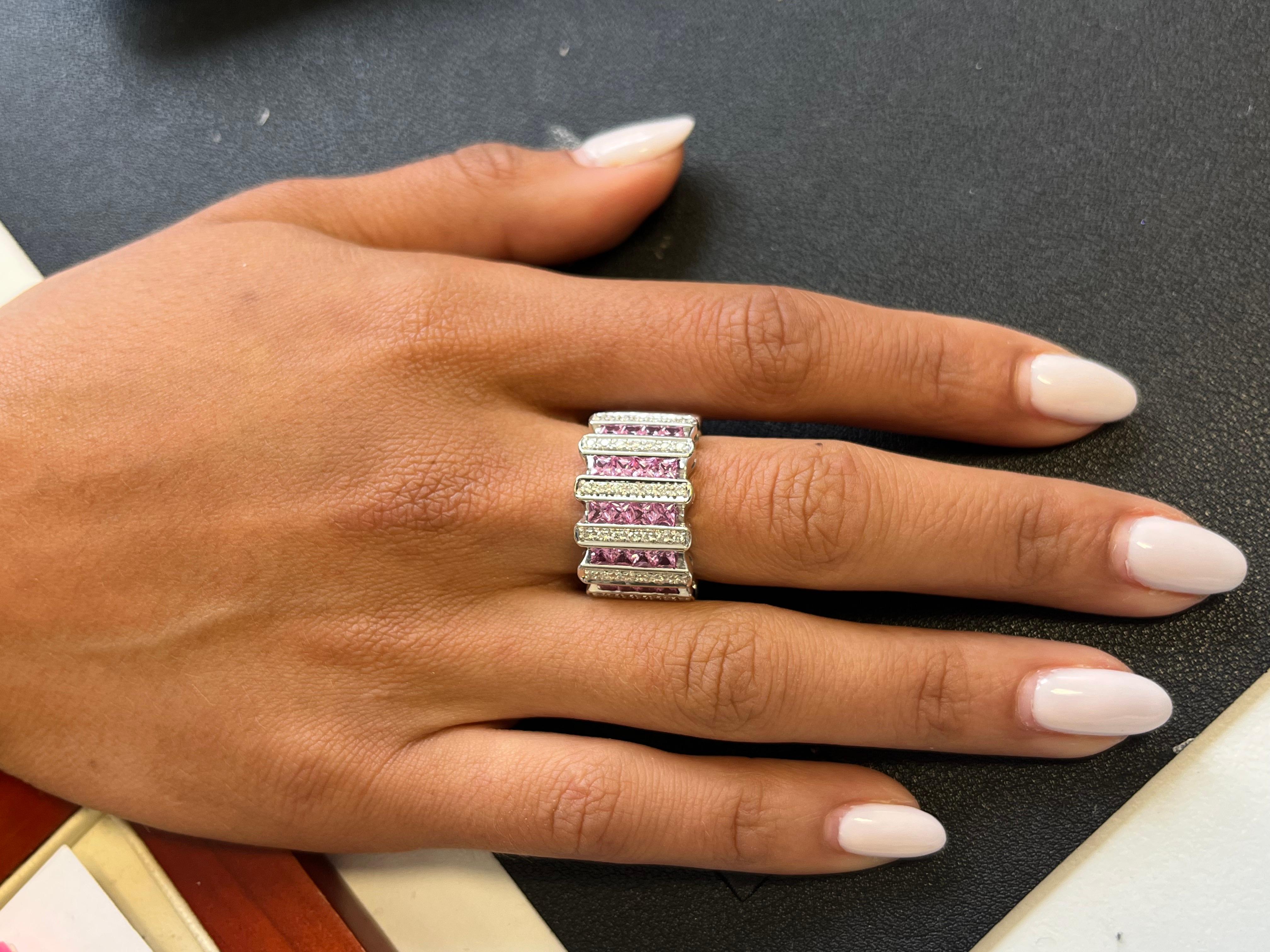 Adorn your hand with the epitome of elegance: a Multirow Ring in 18Kt White Gold, adorned with a captivating 20 princess cut pink sapphire (1.60 carats) and by 42 sparkling full cut diamonds Color H, Clarity VS (0.21 carats). 

Total Weight 16.70