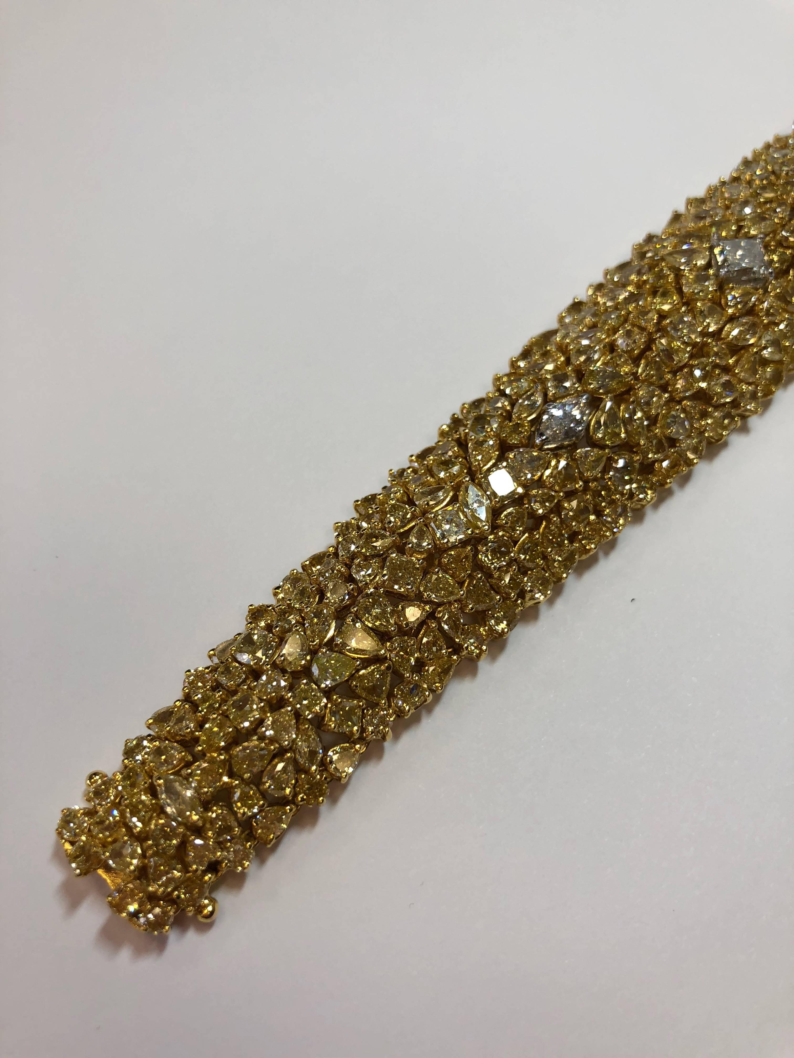 38.08 carats of gorgeous yellow diamonds in multi-shapes with 1.51 carats of white diamond marquise and square shapes in 18k yellow gold.  This cluster design bracelet is classic and perfect for any occasion!  The length of this bracelet is 7