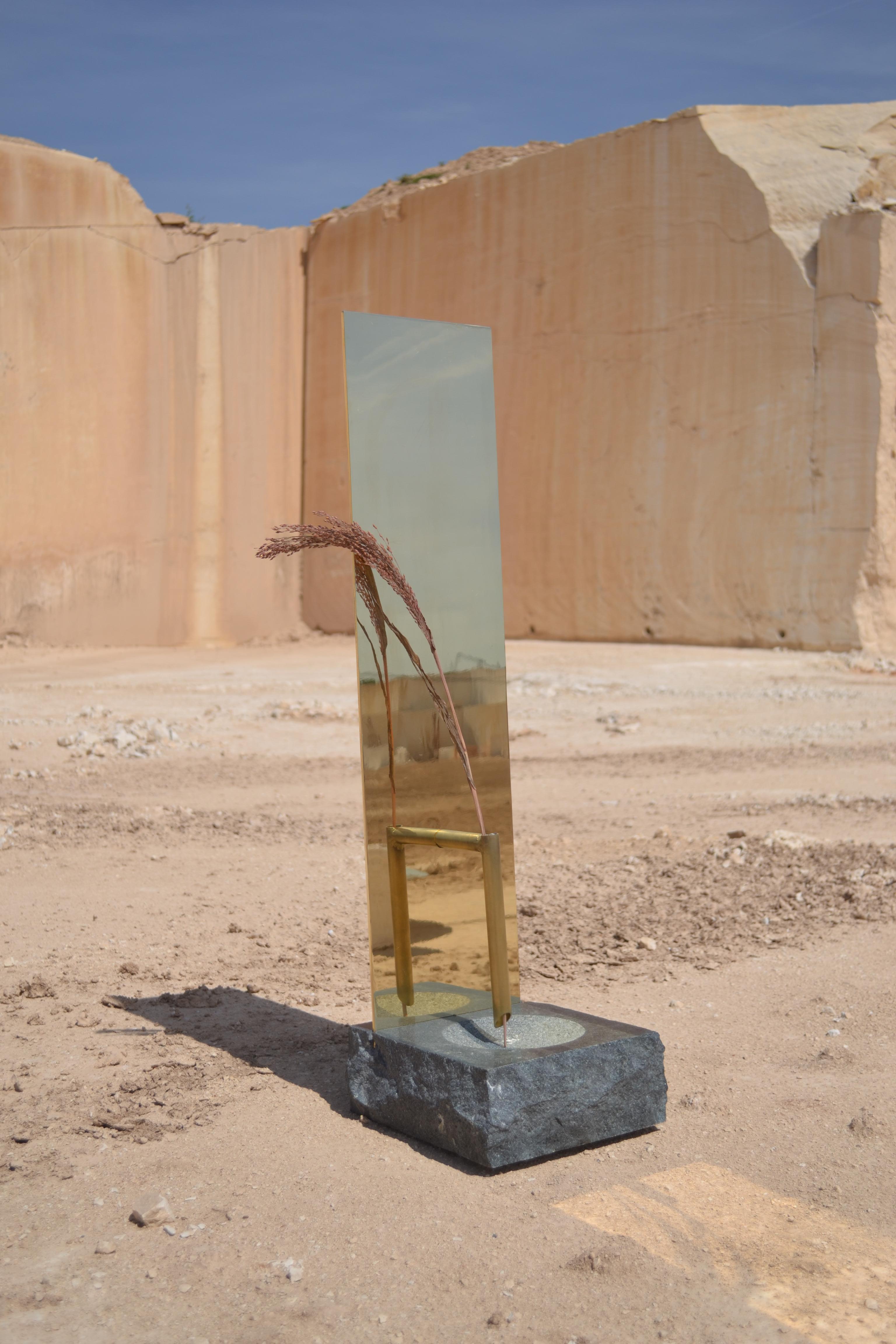 Multiverse is a sculpted vase and a mirror in polished solid 5mm brass and green granite. The granite has been sculpted and carved so that it can be filled with water.
It’s names after the Multiverse-string theory: “Every idea that you already have