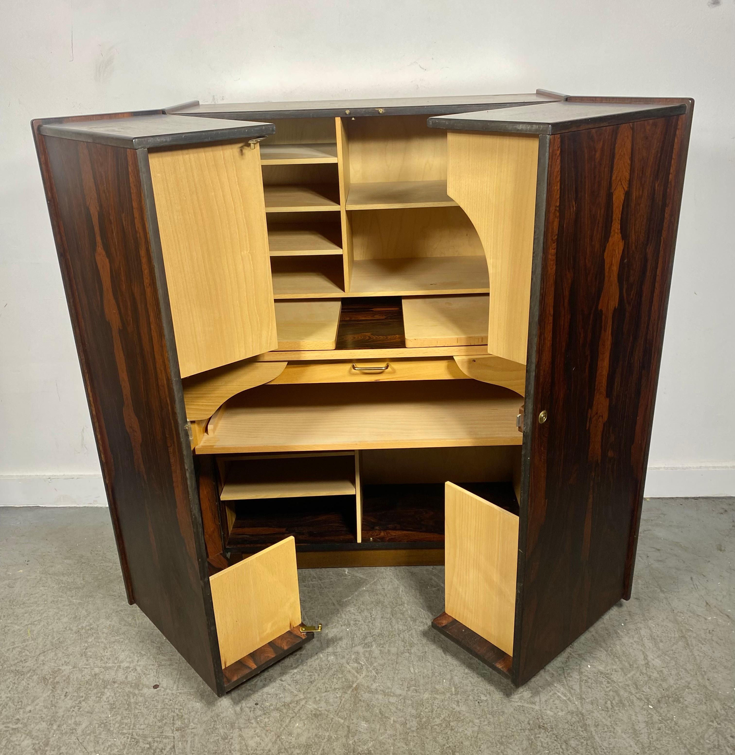 Classic Mid-Century Magic Box by Mummenthaler & Meier. Tall Handsome Cabinet that Opens To An intricate Desk with A Multitude of Storage Space and Shelving. Beautiful richly grained book-matched Rosewood Exterior with Fold Out Desk ... Birch