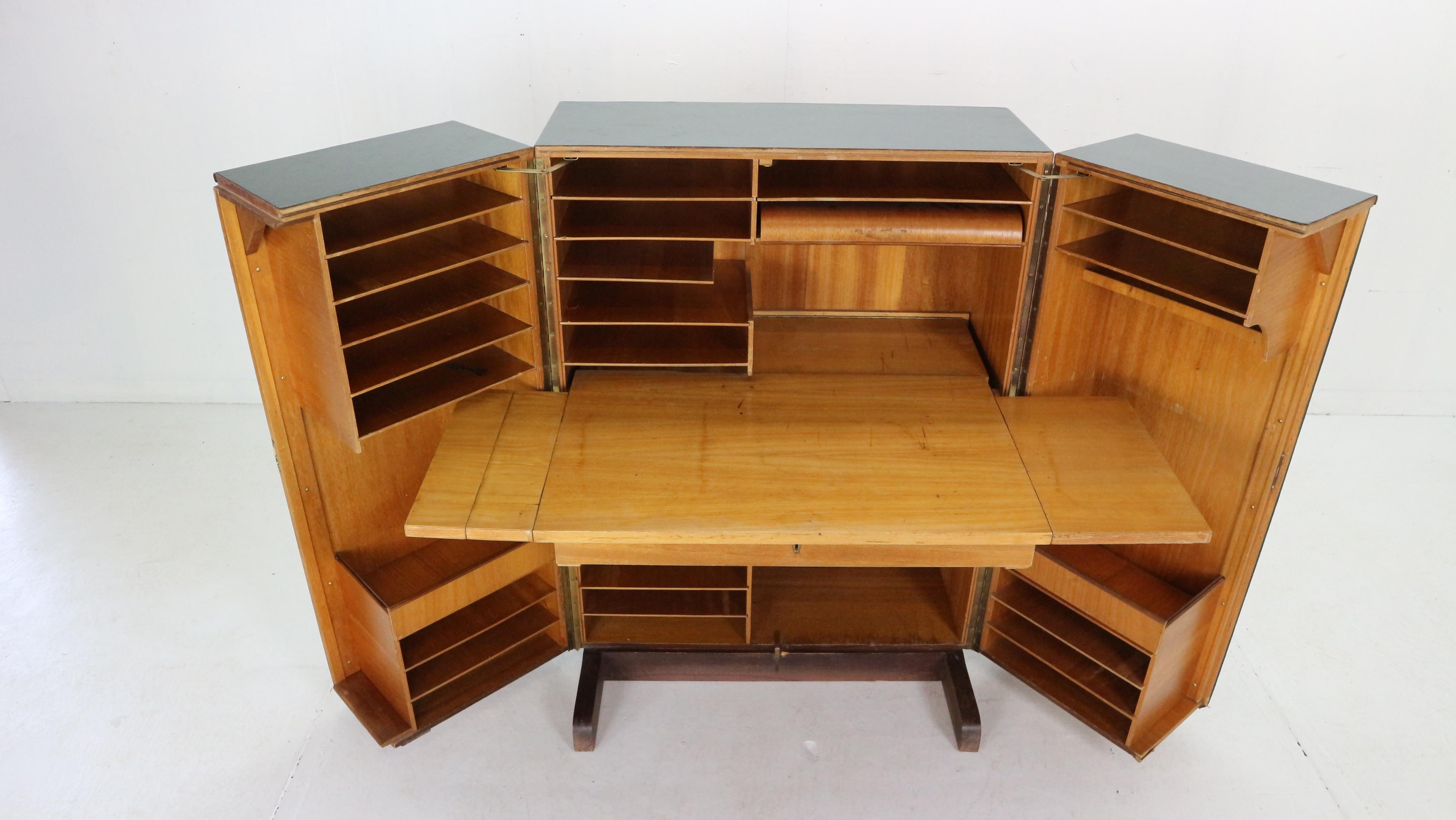 Special edition multifunctional fold out secretary desk, cabinet designed by Swiss architects Ernst Mummenthaler and Otto Meier in 1960's period, Switzerland. 
This cabinet can be transformed to a real working space with drawers, shelves etc. -