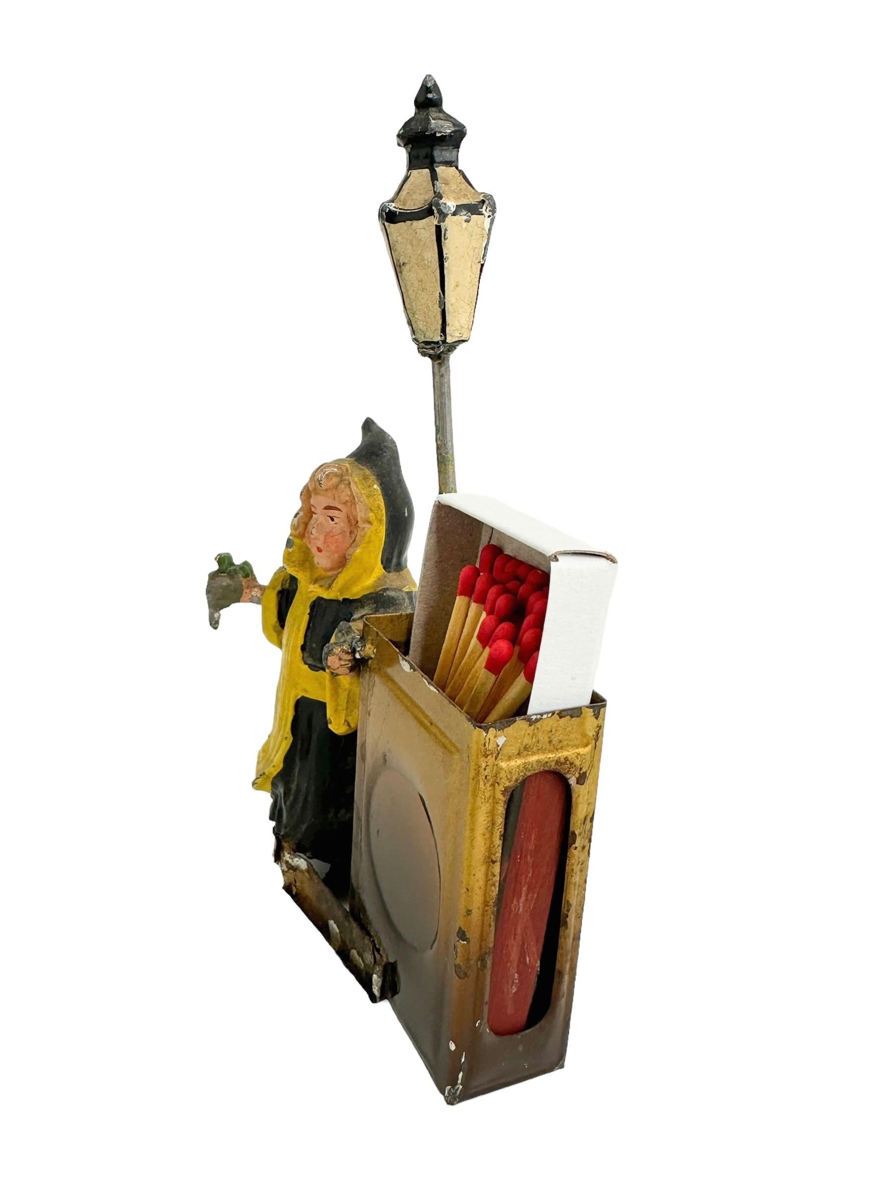 A beautiful matchstick holder stand. Some wear with a nice patina, but this is old-age. Made of metal and hand painted. Little paint lost, but this is old-age and this does not affect the function in any way. A beautiful nice collectible item or