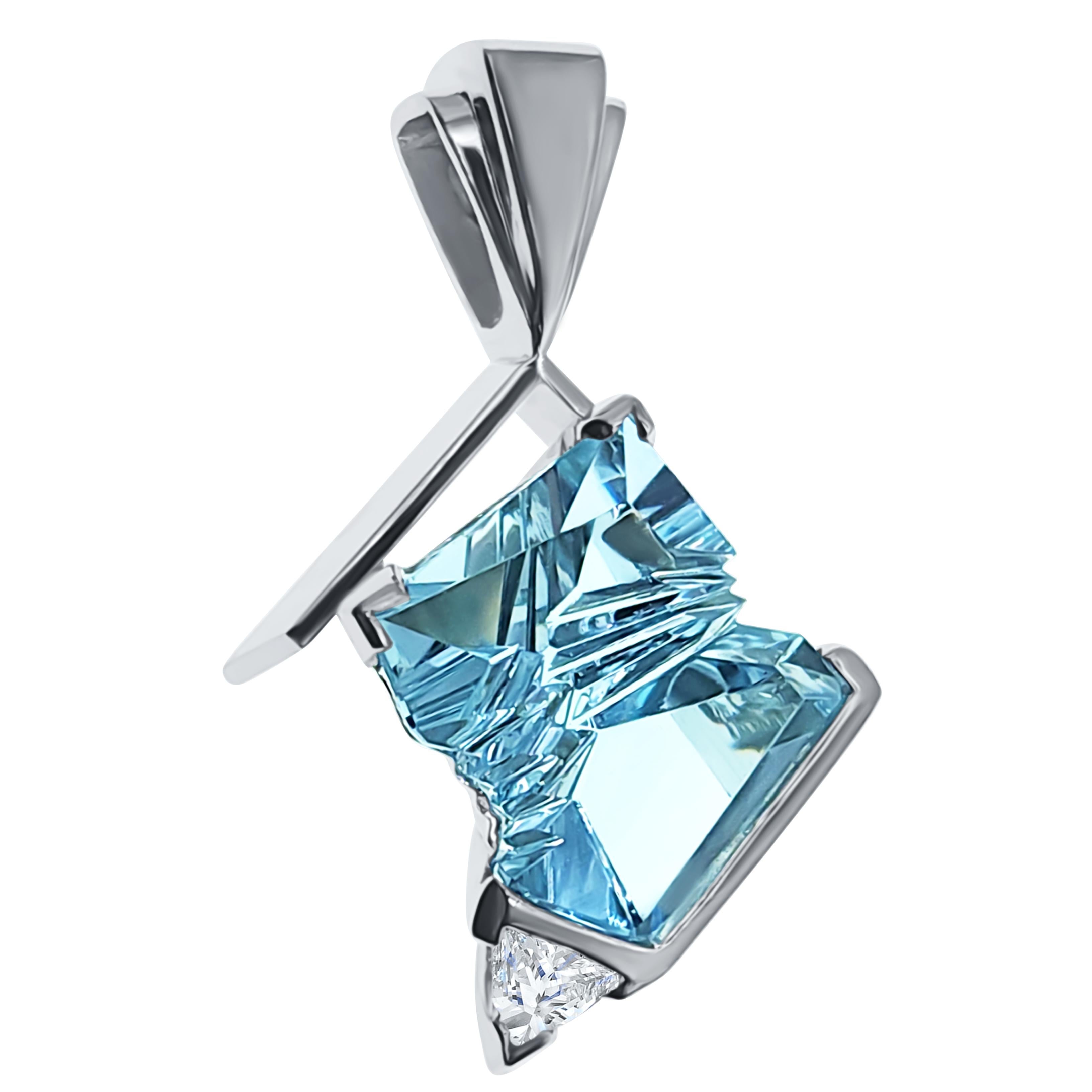 This handcrafted one-of-a-kind pendant by renowned goldsmith, Martha Richter, holds a rare 9.8 carat clean aquamarine, fantasy cut by world famous Bernd Munsteiner. The angular planes of the Aquamarine are reflected on angles of of the 14K white