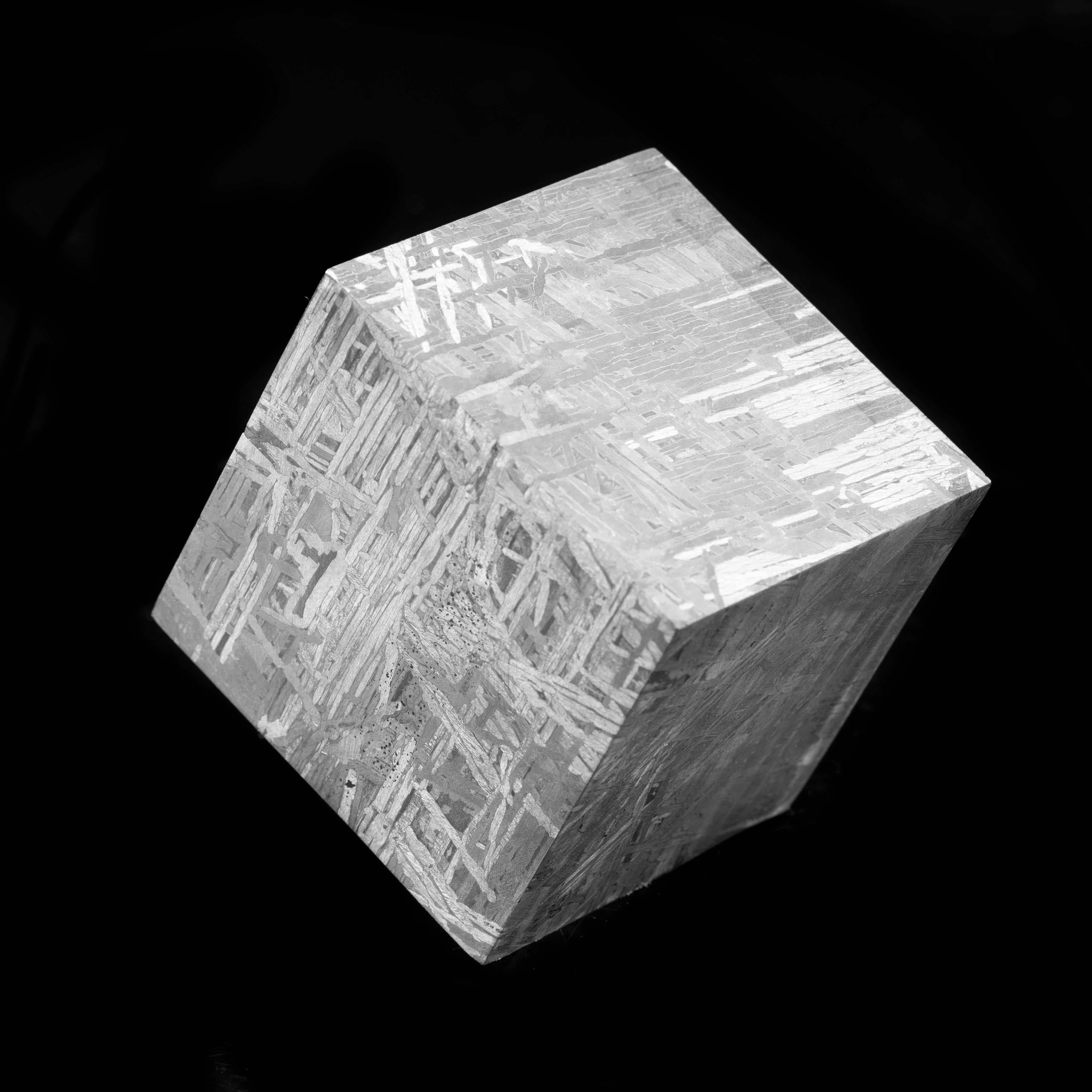 This piece displays the beauty of the Muonionalusta meteorite in the form of a cube. Muonionalusta is a meteorite classified as a fine octahedrite which impacted in northern Scandinavia west of the border between Sweden and Finland about one million