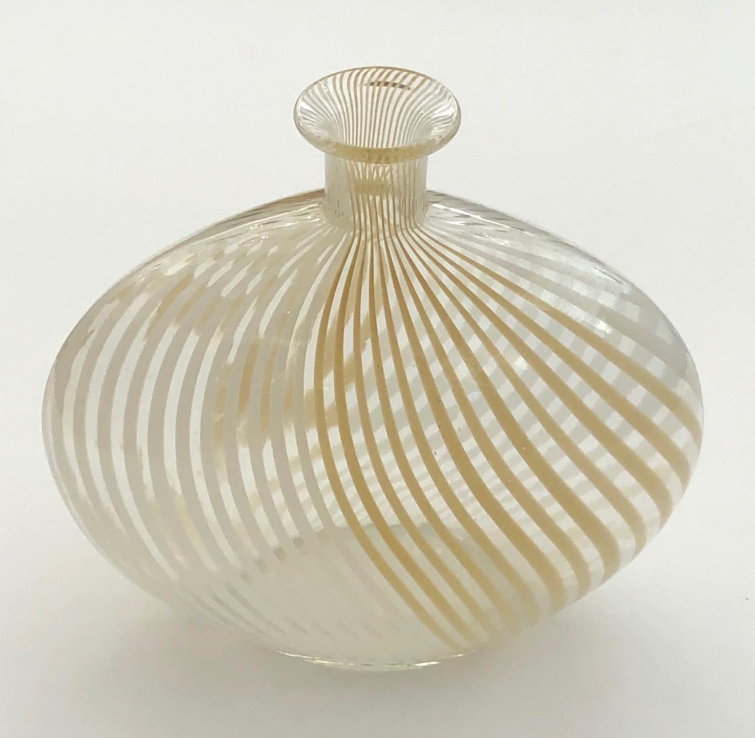 A fine example of a mezza filigrana pillow vase with white and ecru swirled stripes infused into clear glass; the underside with polished pontil.
