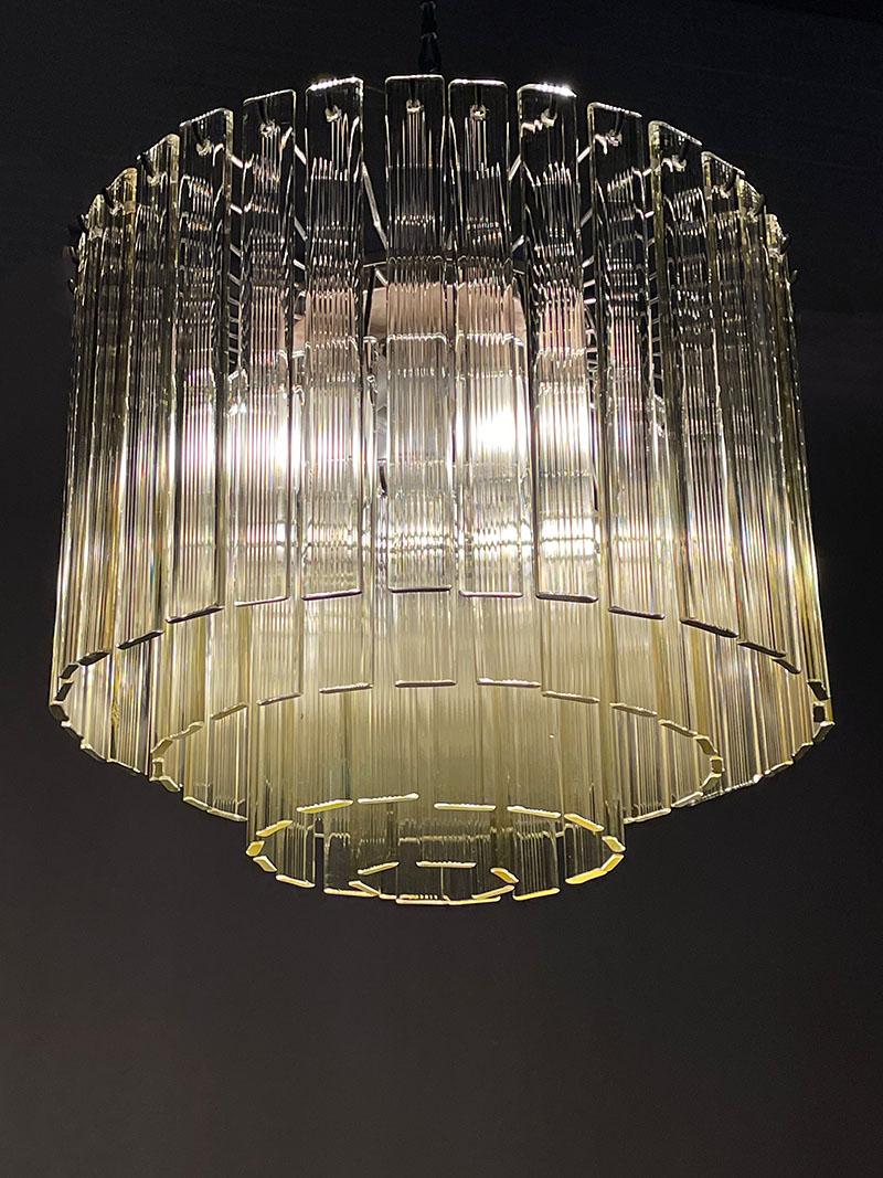Murano 4-tier chandelier with ridged glass blades, 1960s

A Italian Murano chandelier with yellow clear vertical ridged glass blades , made in Italy in the 60's
An metal frame with 4 rows and in total 83 glass blades to hang

The upper row has 35