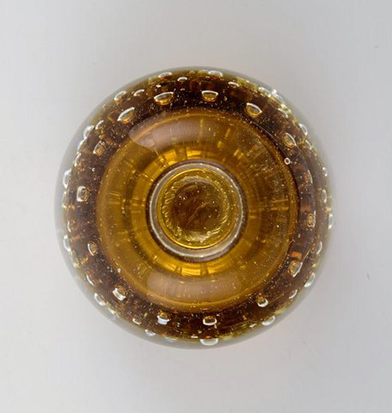 Murano, amber colored candleholder in mouth blown art glass, 1960s.
Designed with bubbles in the glass mass.
In perfect condition.
Measures: 8 x 5.5 cm.