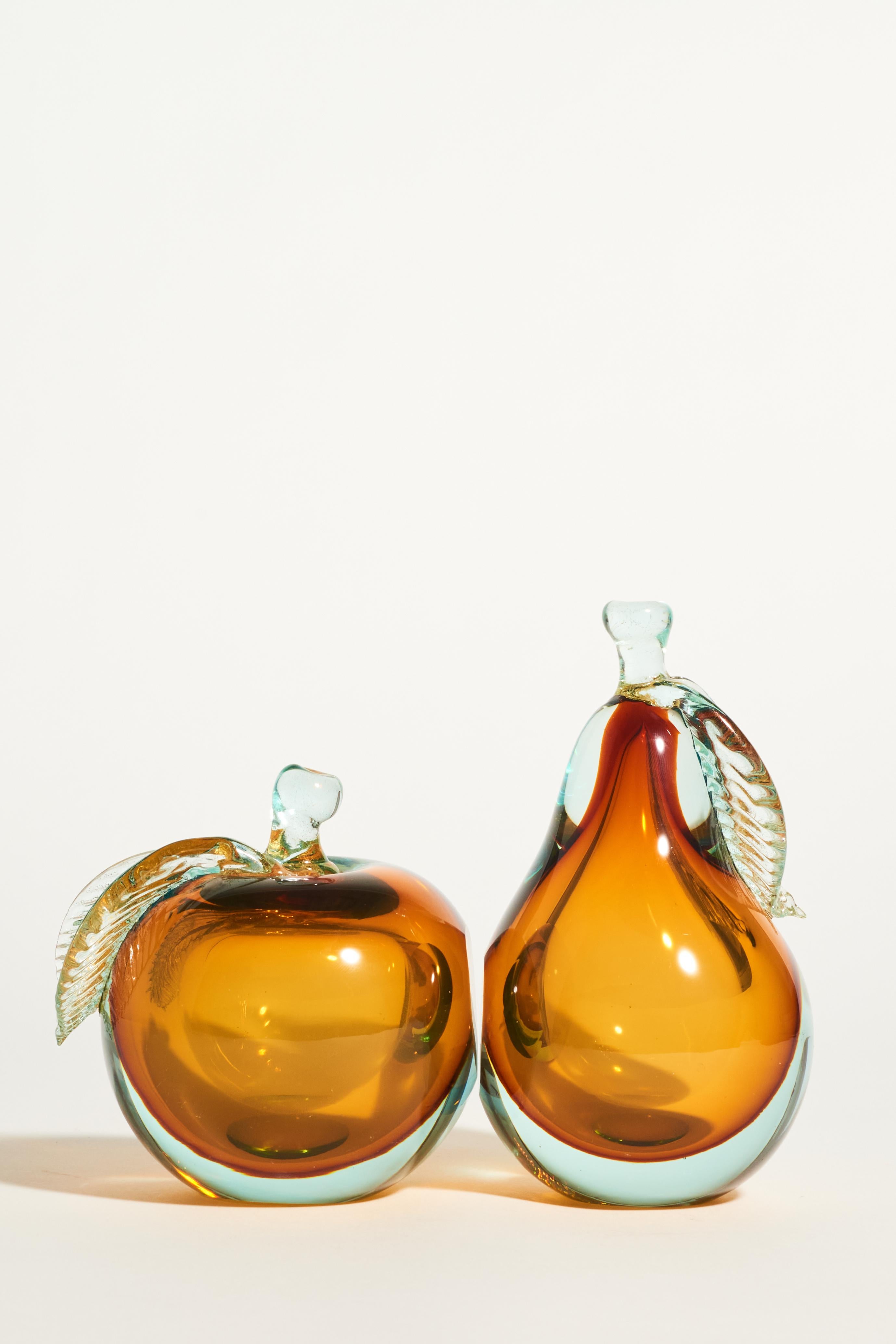 Murano glass bookends with deep golden amber interior overlaid in pale green tinted glass flecked with gold on the stems and leaves

 Apple: 4