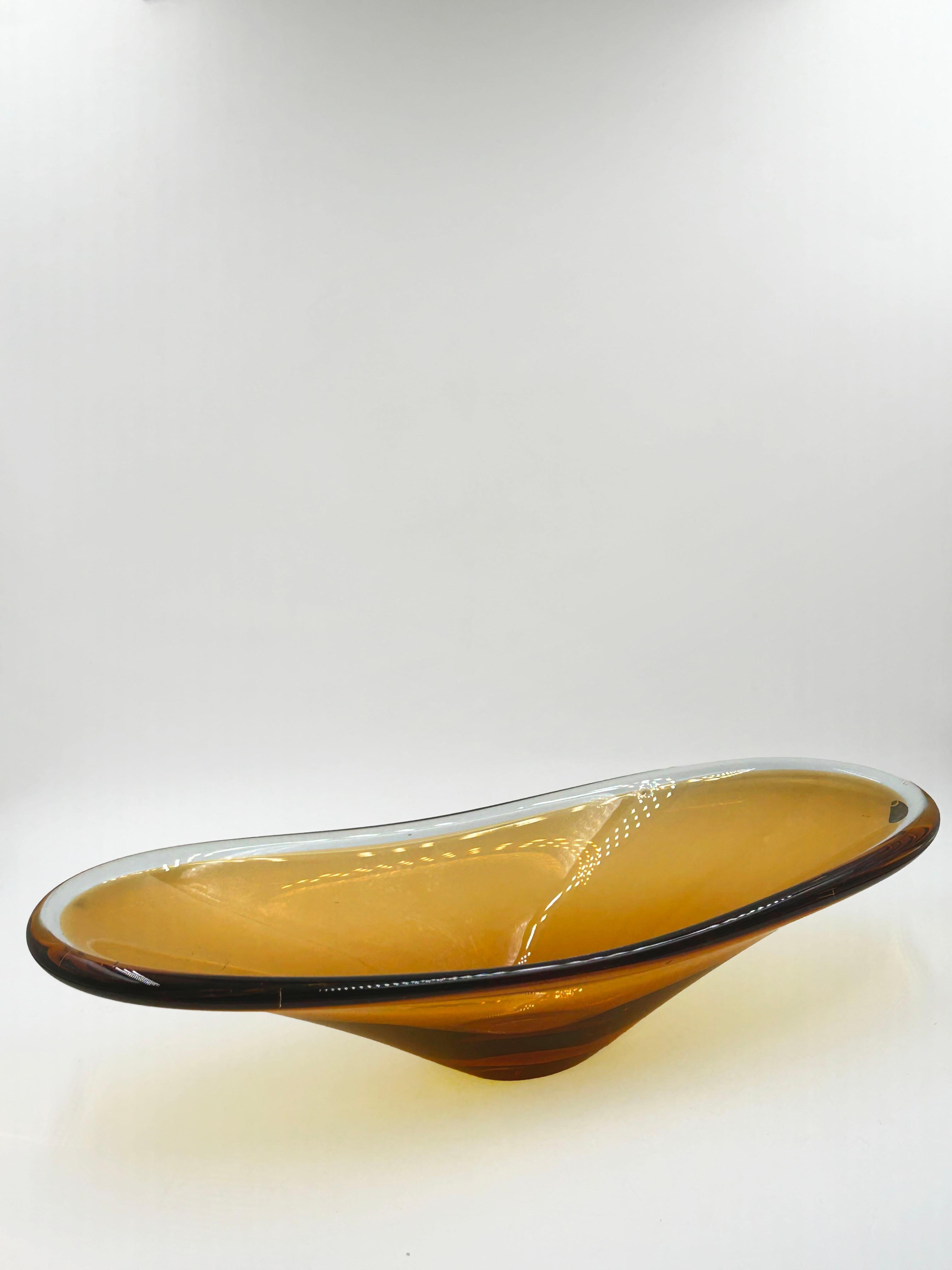 Murano Amber Glass Centerpiece Bowl, Italy, 1970s

Elegant hand-blown Murano glass centerpiece from the 1970s, featuring a warm amber tone and a fluid, elongated form. The piece showcases the signature craftsmanship of Murano glassmakers, with its