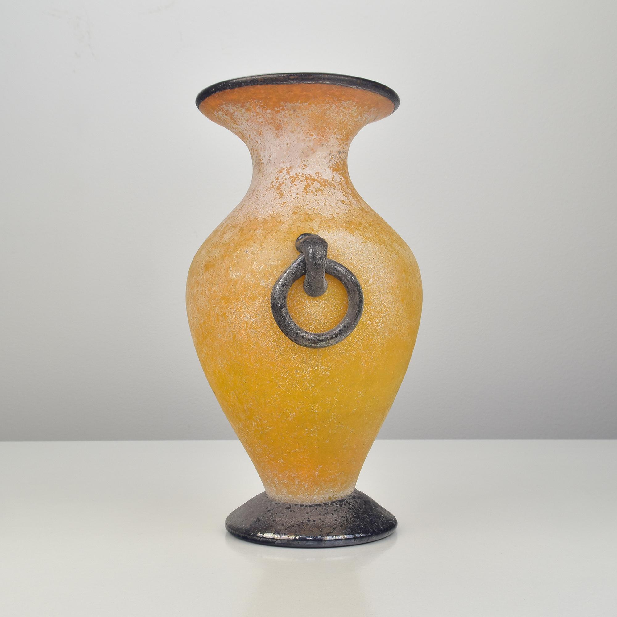Vibrant yellow art glass vase with black upper rim and black door knocker or hooked ring decoration to the body probably made by Archimede Seguso.

Archimede Seguso (1909 - 1999) was a prominent and highly influential Italian glass artist and master