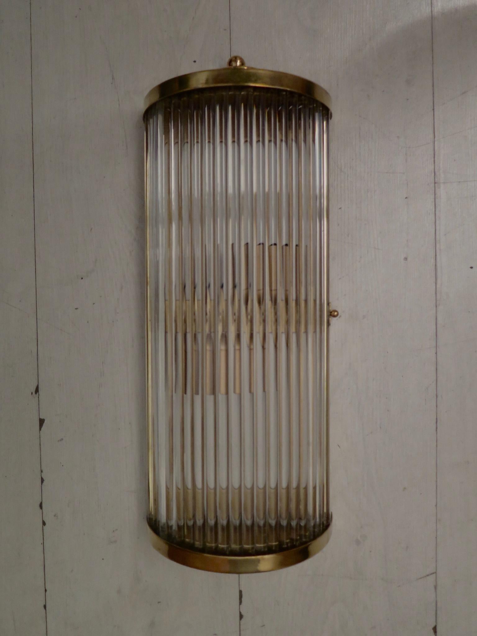 Murano Art Deco wall light. Six splendid wall light from a renovated hotel in Venice.

All-brass structure, semicircle shaped. Along its perimeter are inserted transparent glass rods. In the upper part and in the lower part there are some brass cups