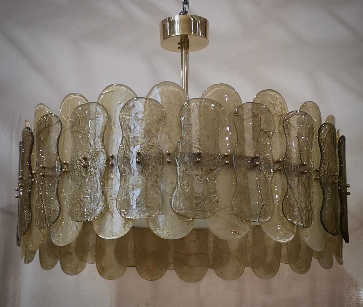 Fantastic round chandelier in Murano glass and polished brass. Note the shape of the amber and smoky Murano glass plates, very beautiful and particular. Simple but very elegant linear Murano chandelier.

Murano chandelier in artistic glass and