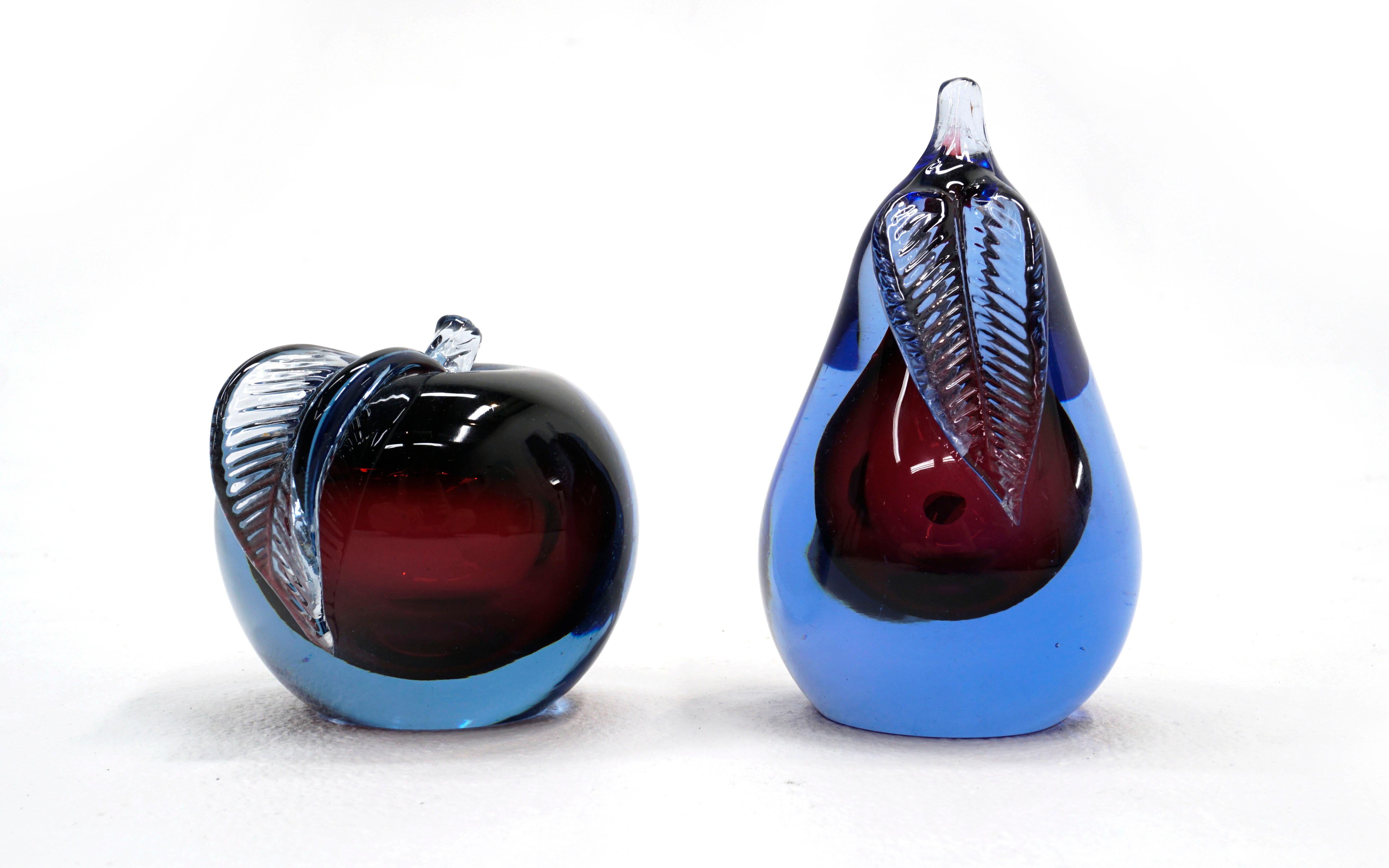Murano art glass apple and pear Sommerso blue and purple designed by Alfredo Barbini. Both have two flat surfaces for display or can be used as bookends. No chips or repairs. May show minor wear on flat surfaces.