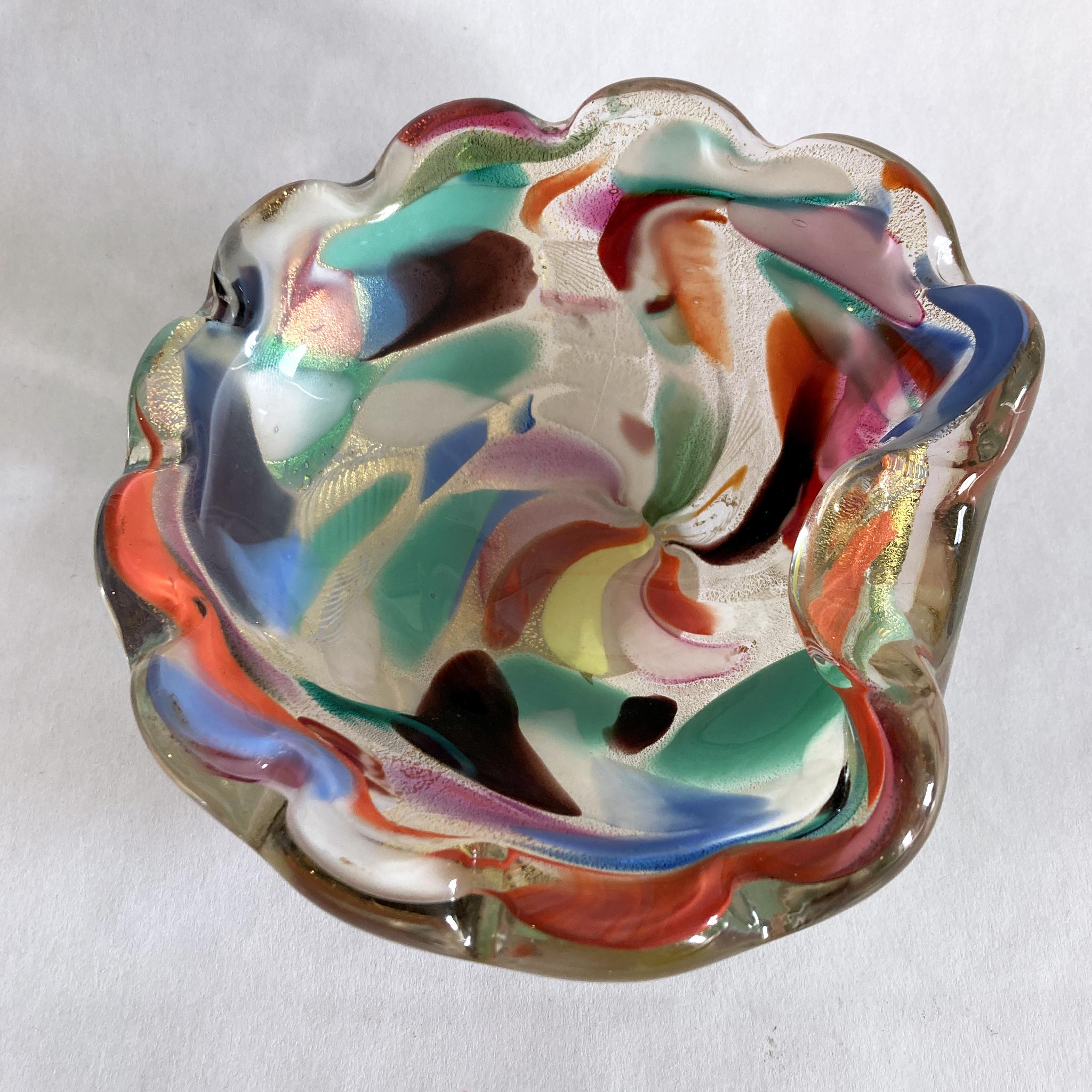 Stunning, unique Murano hand blown bowl/ catchall. Bold colors swirl through this Arte Vetraria Muranese (AVEM) scalloped-edge bowl, with gold underneath. The glass glitters when the light hits this piece at different angles. Shades of blue, pink,