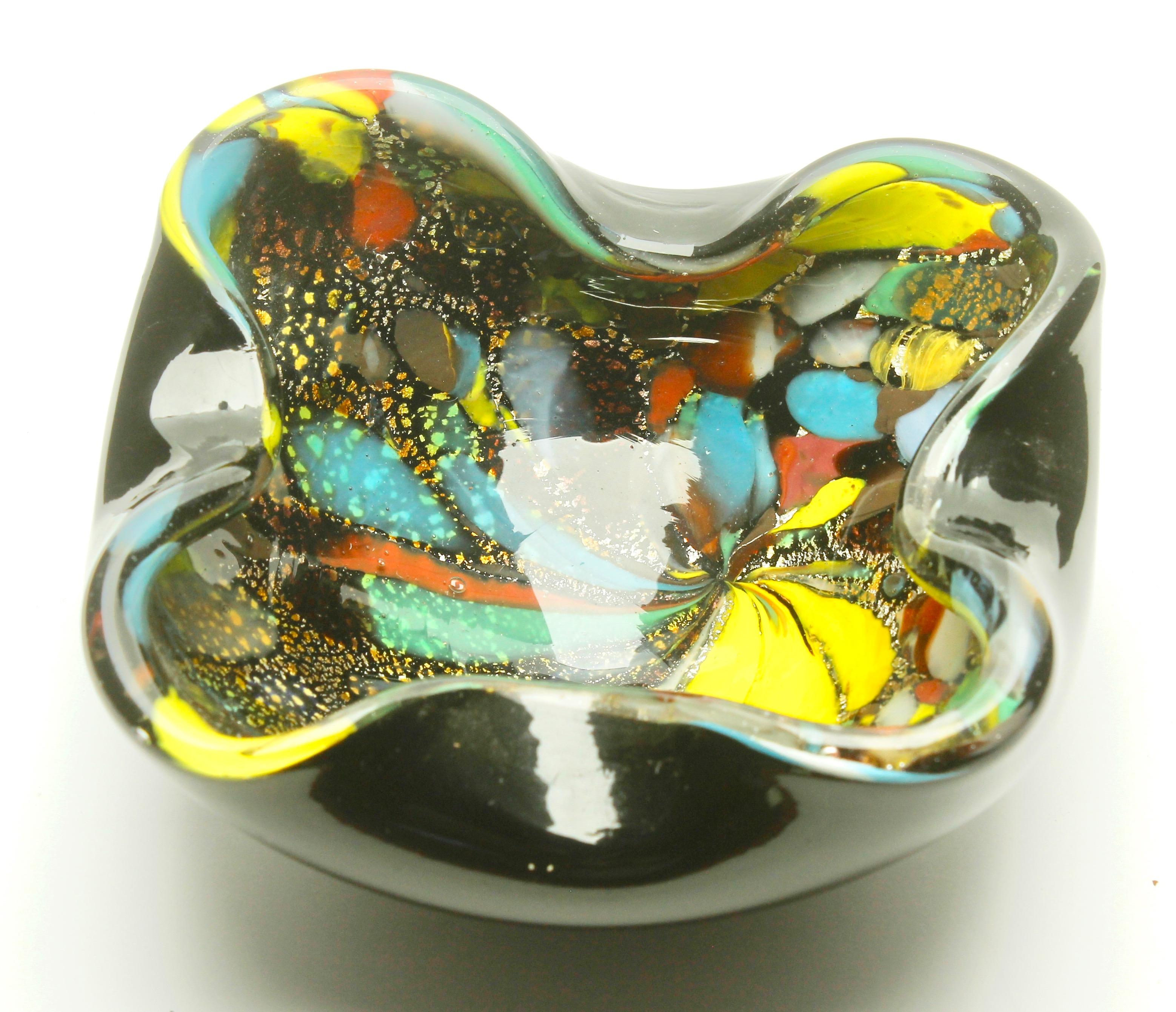 Stylish Murano art glass bowl attributed to AVEM and made in the 1960s. Distinctive black casing on the outside with colorful spatter-glass interior in bright and contrasting colors with silver and copper aventurine inclusions. Polished