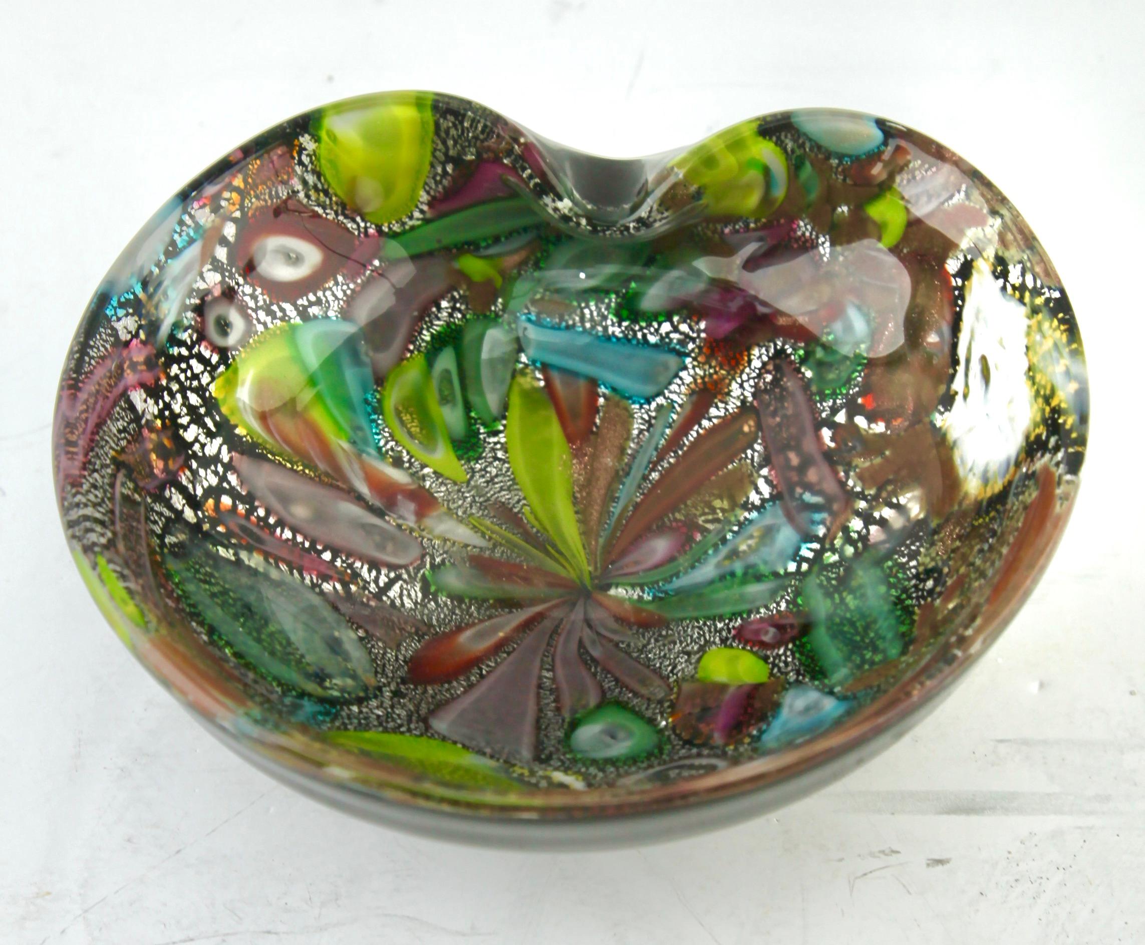 Stylish Murano art glass bowl attributed to AVEM and made in the 1960s. Distinctive black casing on the outside with colorful spatter-glass interior in bright and contrasting colors with silver and copper aventurine inclusions. Polished