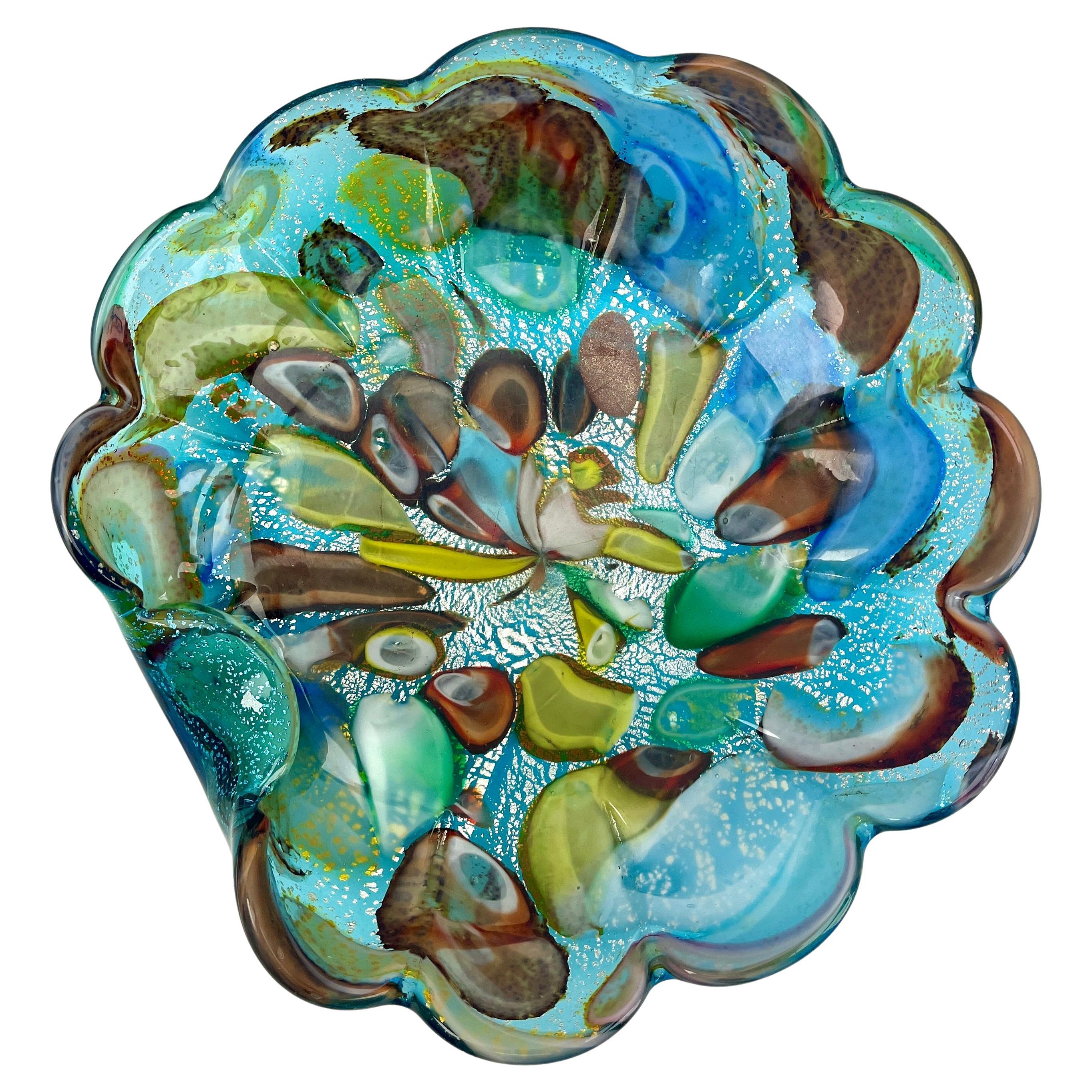 Stylish Murano art glass bowl attributed to AVEM and made in the 1960s. Distinctive black casing on the outside with colorful spatter-glass interior in bright and contrasting colors with silver and copper aventurine inclusions. Polished base.
Italy,