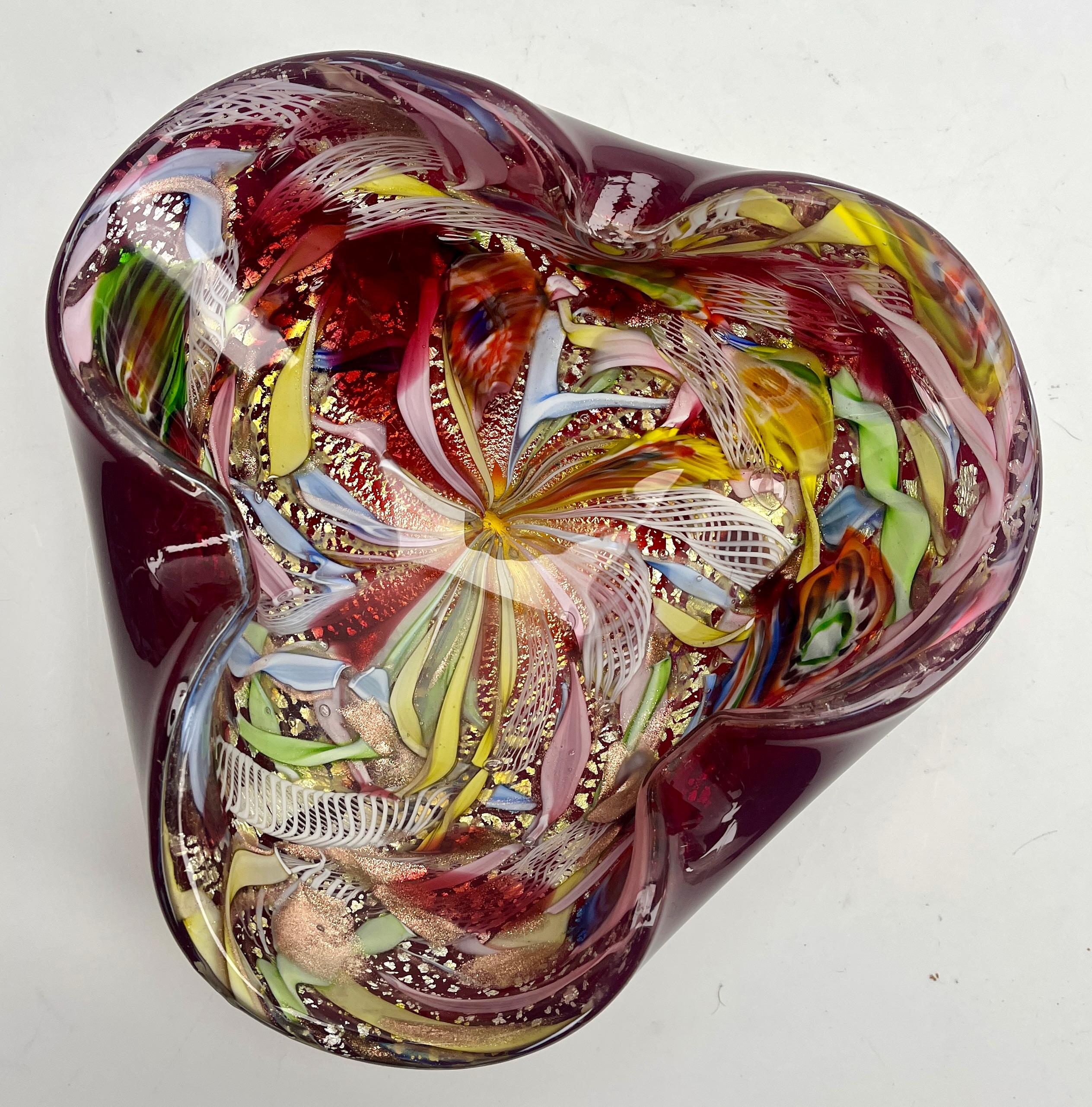Stylish Murano art glass bowl attributed to AVEM and made in the 1960s. Distinctive Red casing on the outside with colorful spatter-glass interior in bright and contrasting colors with Gold, silver and copper aventurine inclusions. Polished