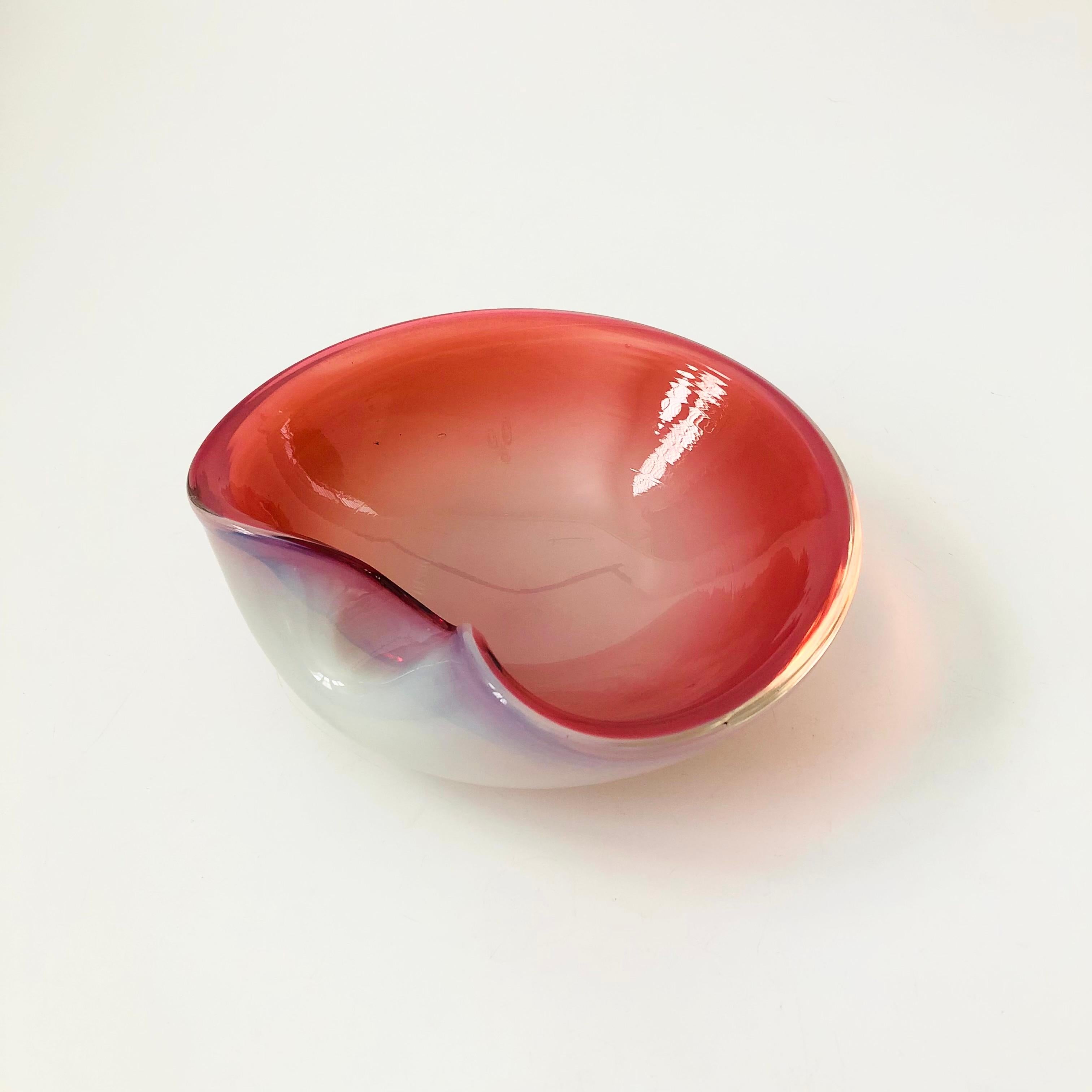 A vintage art glass bowl by Murano. Beautiful layered pink and white color to the thick glass with a folded edge. Remnants of the original recognizable made in Italy, Murano sticker still attached to the base.

