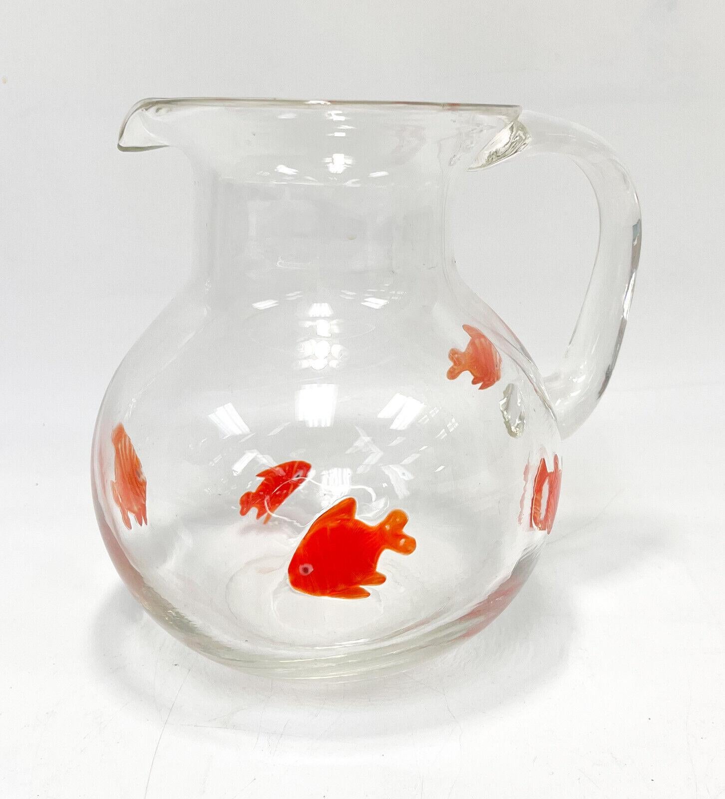 Murano art glass water pitcher. With applied cased orange sunfish throughout the exterior. Unmarked. Polished pontil to underside.

Additional Information: 
Type: Water Pitcher
Materials: Glass
Weight Approx., 1 lbs
Measures Approx., 8.5 inches