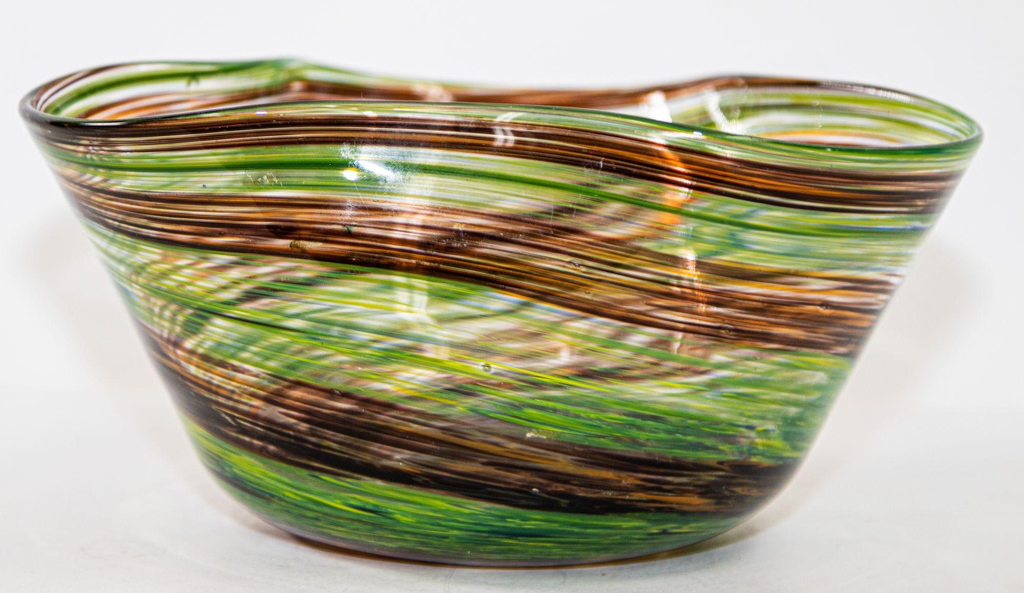Vintage colored striped vase in Murano hand blown glass clear with green and brown colored bowl.
Murano Art Glass decorative bowl, realized with a swirl of brown and green orange pattern.
A vintage 1980s Venetian striped glass decorative