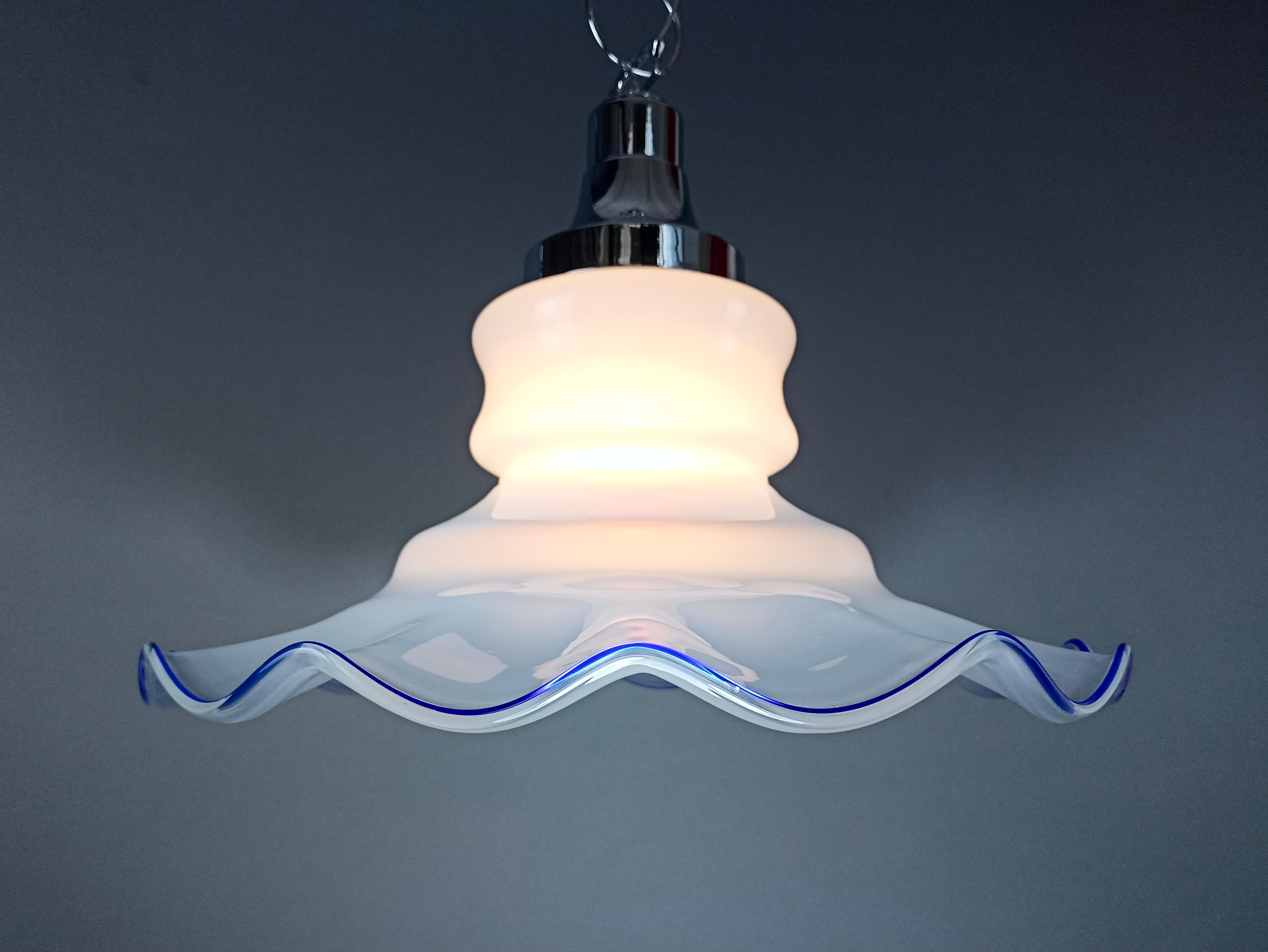Murano glass Fazzoletto 1970s large one-light fascinating Italian pendant lamp. Chain and frame in chromed metal, lampshade in milky white Murano 'Lattimo' art glass, shaded towards the edge and with a fine blue glass finish.
The so-called