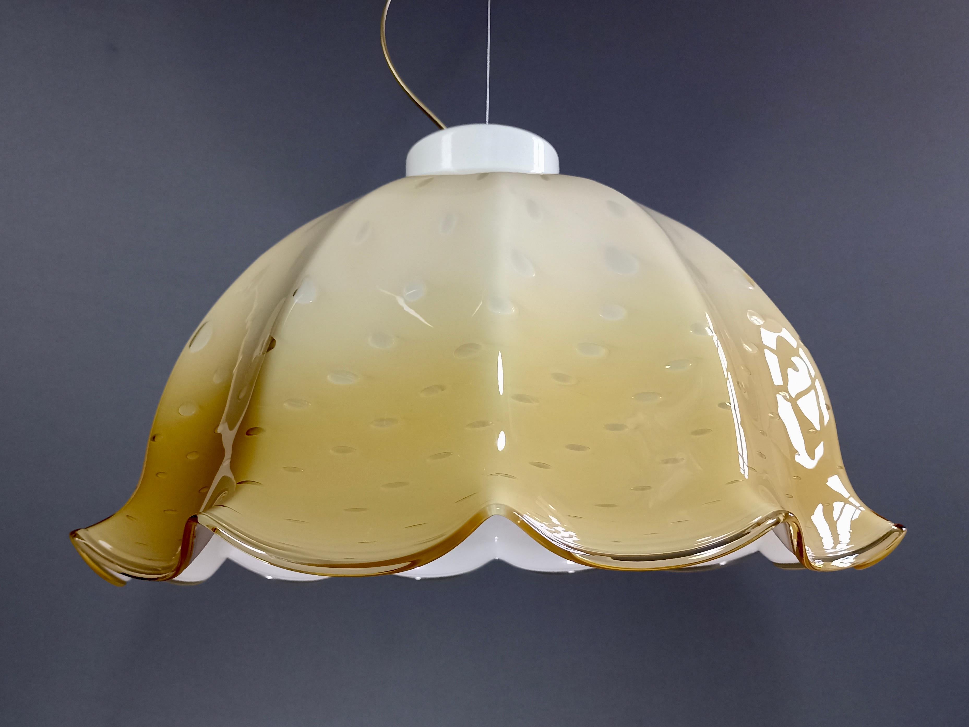Stunning Murano hand-blown art glass one-light pendant lamp from the 1960s. 
The large lampshade is shaded cream color (see photos) cased glass, with beautiful bubbles of Bulicante workmanship and an elegant glass curb finish around the