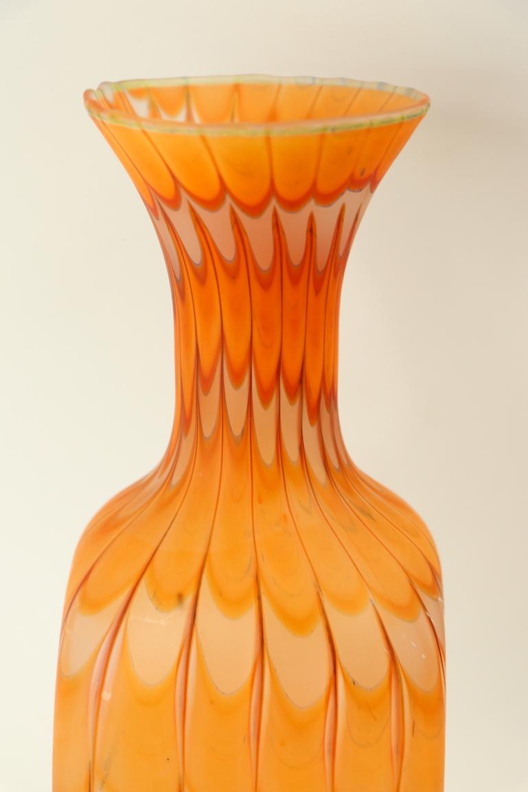 Well executed Fenicio vase by Fratelli Toso, in perfect condition. This example has orange and white colorings which create a wavy surface. Hard to find midcentury item from the recognized master studios of Fratelli Toso, Murano, Italy.