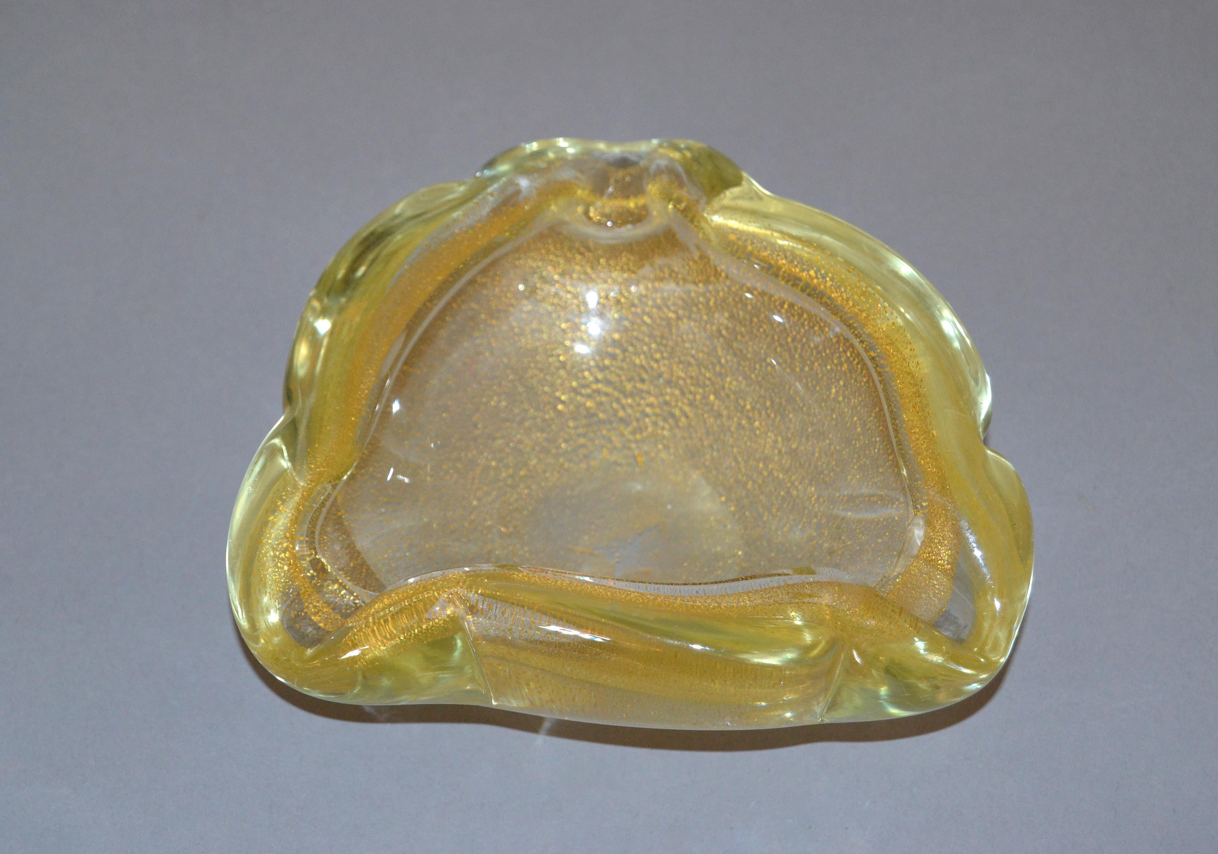 Clear Murano art glass ashtray, catchall or bowl made in Italy.
Heavy gold filled glass with gold speckled.