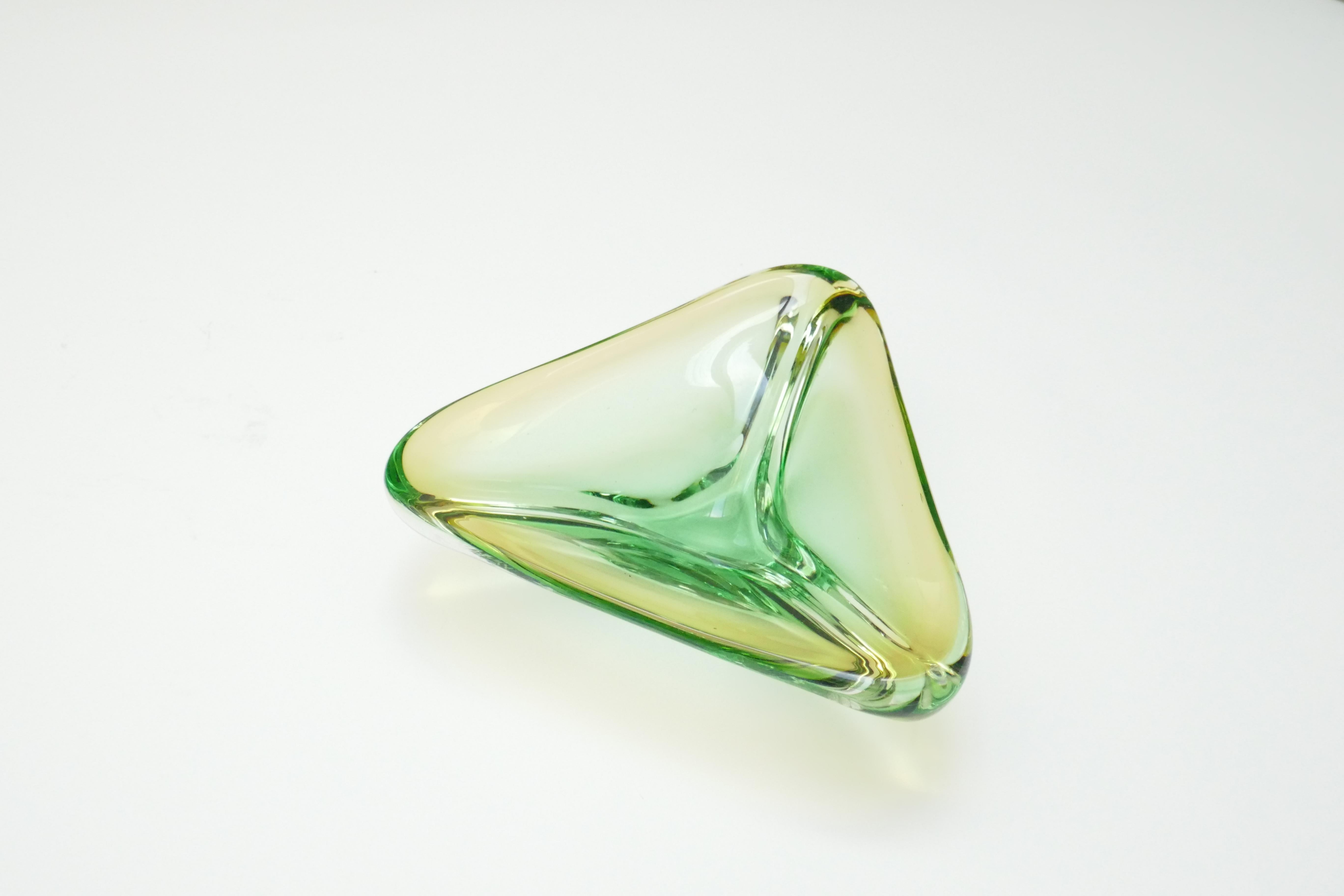A very stylish Venetian Murano glass object in triangular shape and a pretty beautiful green and clear colour. with an amber rim. Using the renowned Sommerso technique the bowl has green glass encased in a clear base with an amber rim.
 A highly