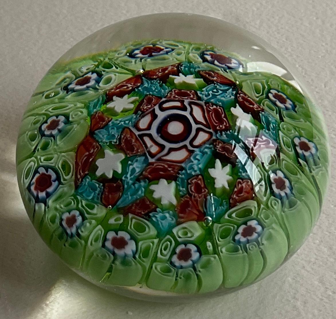 An authentic Fratelli Toso Murano Millefiori paperweight with roses and flowers that will spark your imagination every time you put your eyes on it.

This art piece has faceted edges and controlled bubbles. 
Hand blown and bursting with colors: