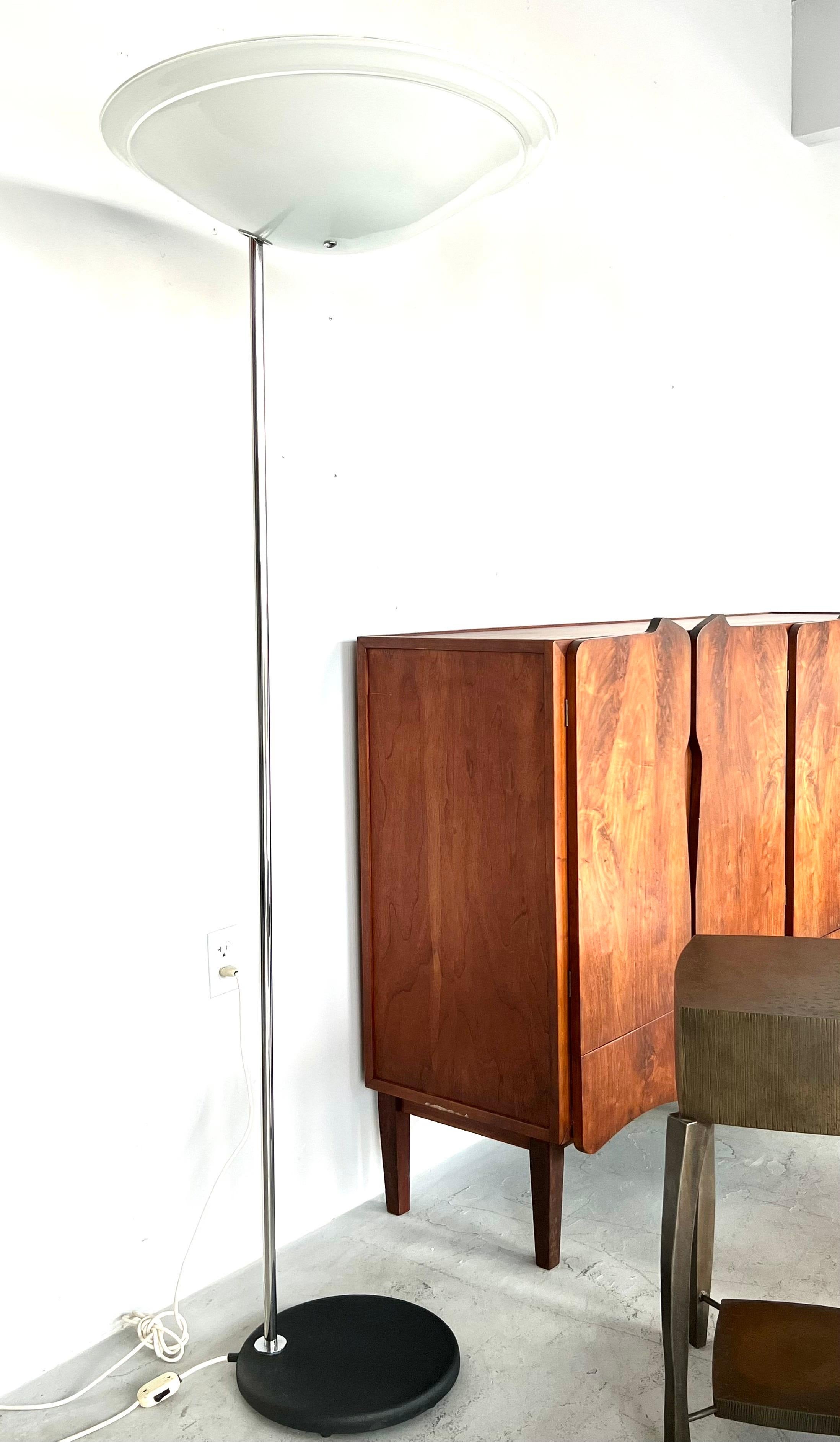 A modernist Italian floor lamp. The large cantilevered top is white Murano glass with clear banding. Nickel pole with a black enameled base. The glass bowl is 25