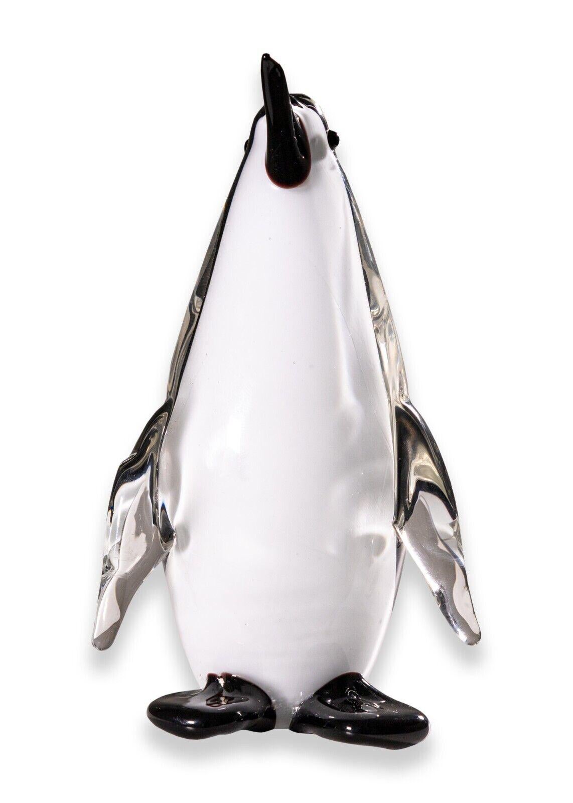 A Murano art glass penguin figurine sculpture with original tag. A super cute little glass figurine of a quaint little penguin. This glass piece is from world renown glass maker Murano. This piece also features the original Murano tagging on the