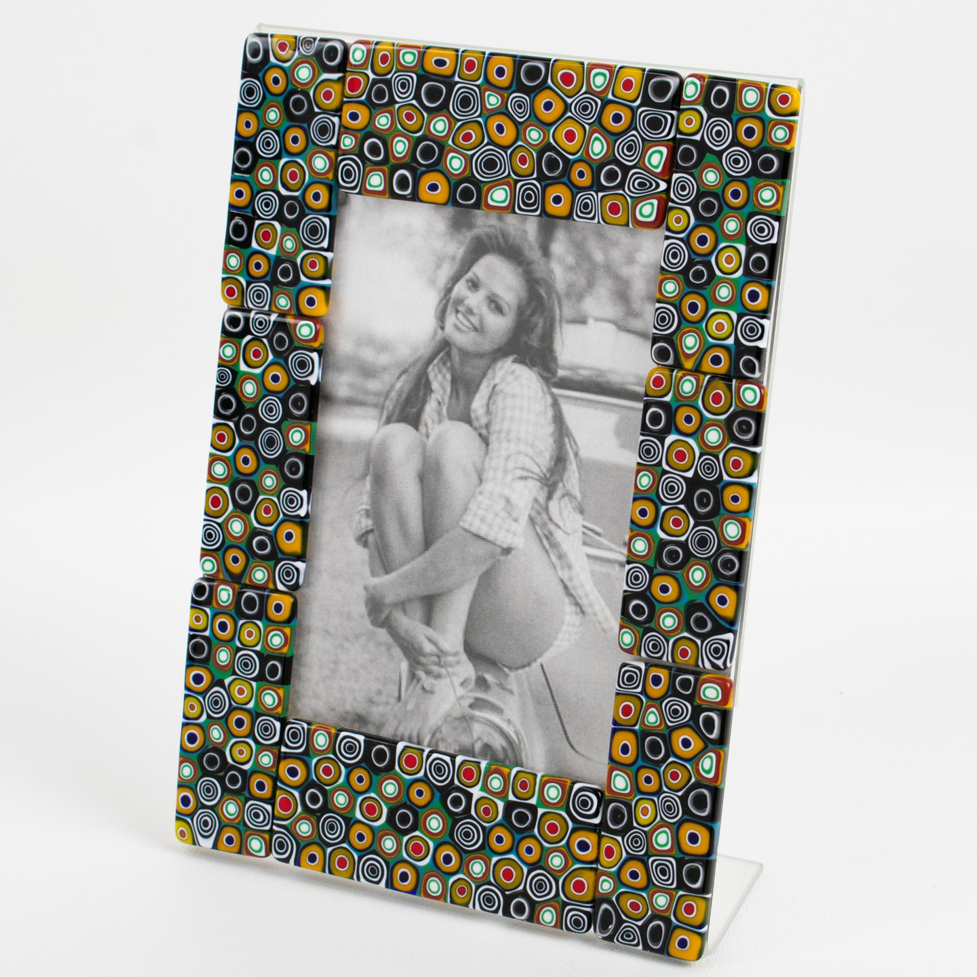 This stunning Murano art glass picture frame was hand-crafted in Italy in the 1990s. Murano mosaic, colorful Murrine plaques adorn the picture frame's view, which features an L-shaped clear Plexiglas frame. The Murrine glass panels come in a large