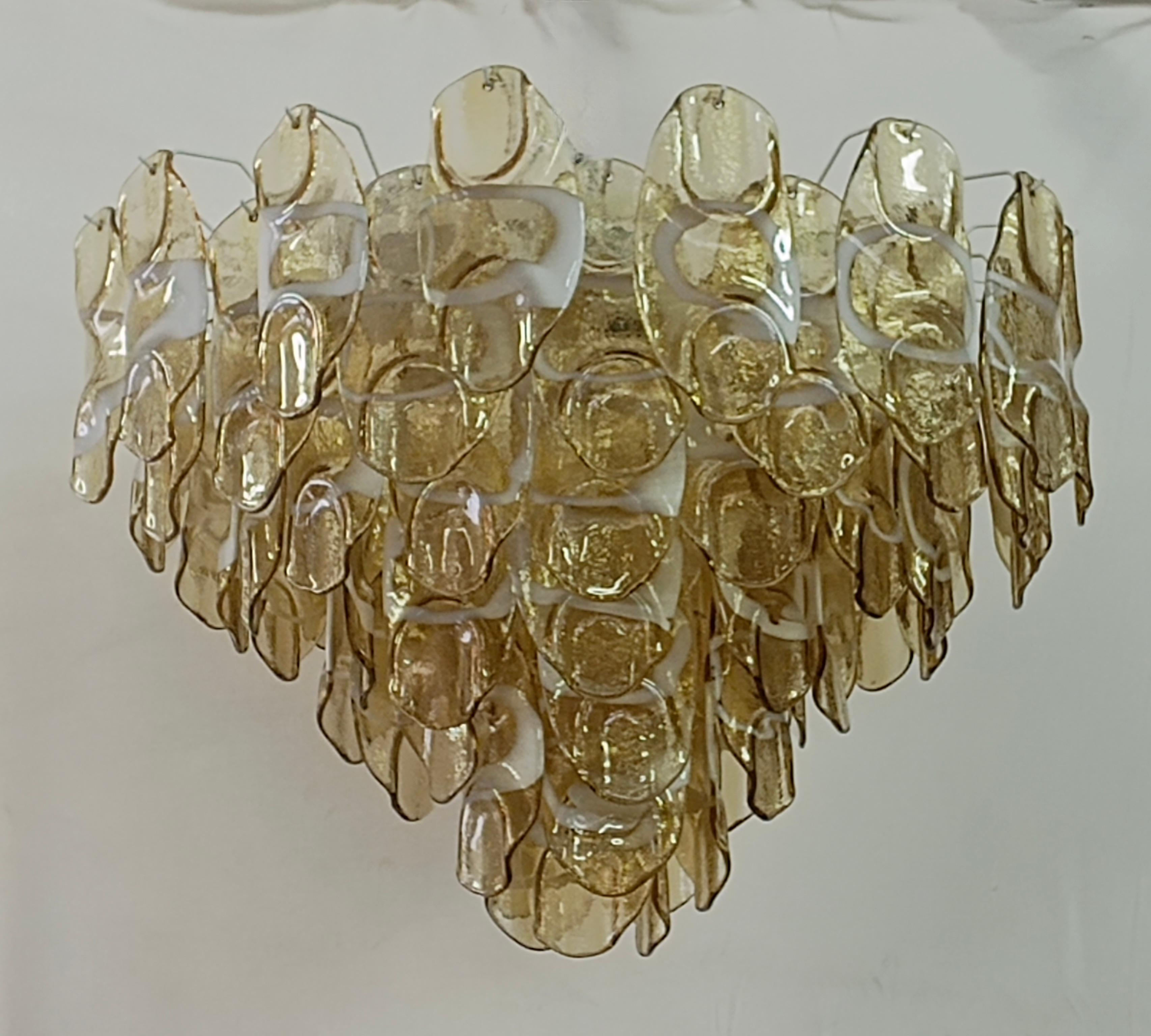 Fantastic Venetian amber and white color for a Cascade of Murano leaves. A striking color for this chandelier.

All in Murano art glass with amber leaves placed all around. The color of this very Classic Murano chandelier is very light amber with an