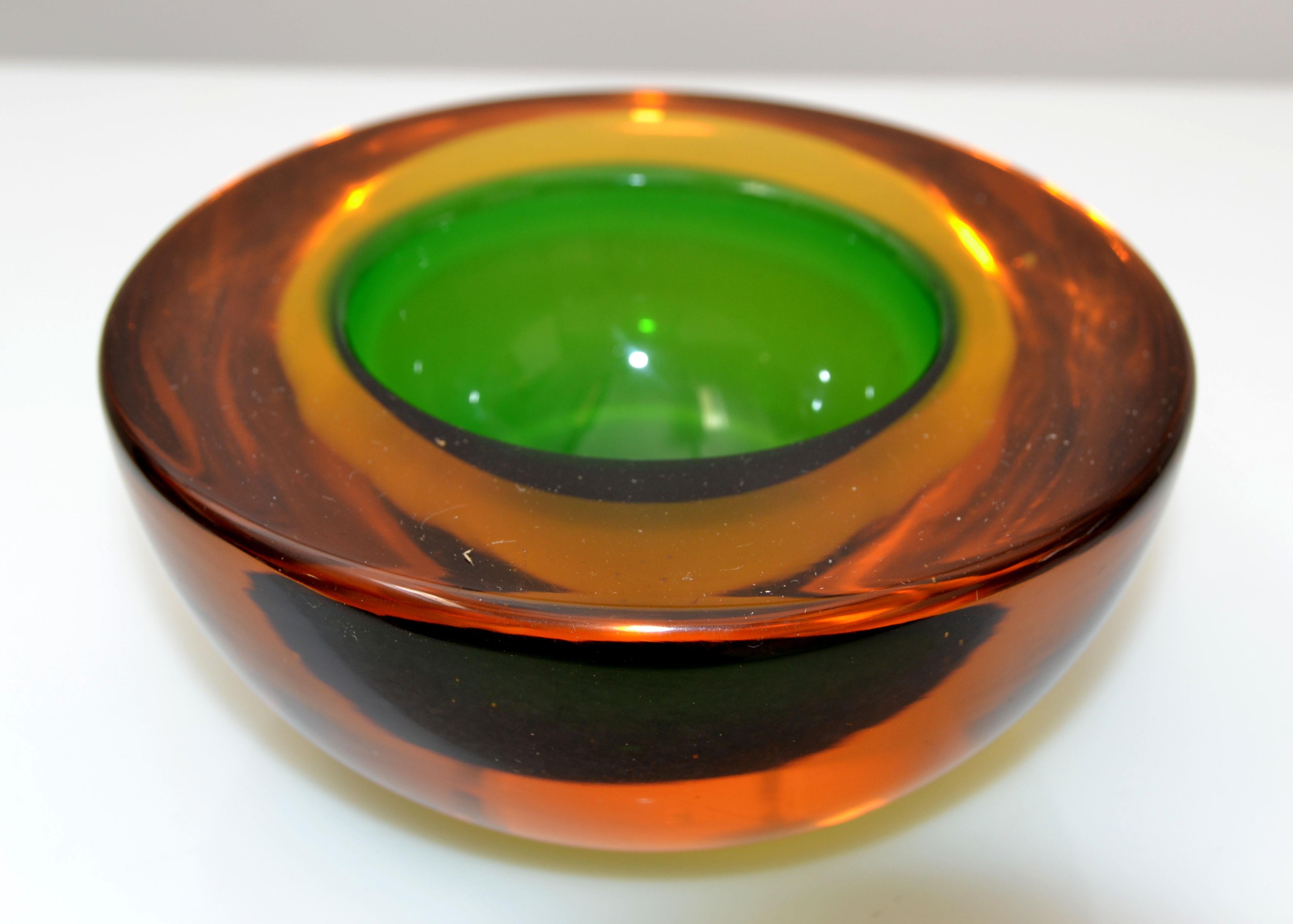 Mid-Century Modern Murano art glass bowl in amber and green, blown glass catchall, made in Italy.
Heavy glass bowl with outstanding details.
 