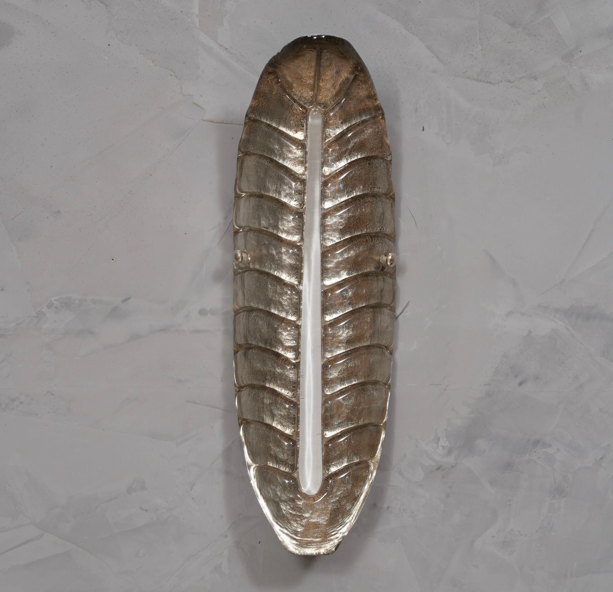 Beautiful design for this leaf-shaped applique, all silver with a vertical white rib.

The applique is made up of a single piece of Murano glass, almost as if it were a Murano 