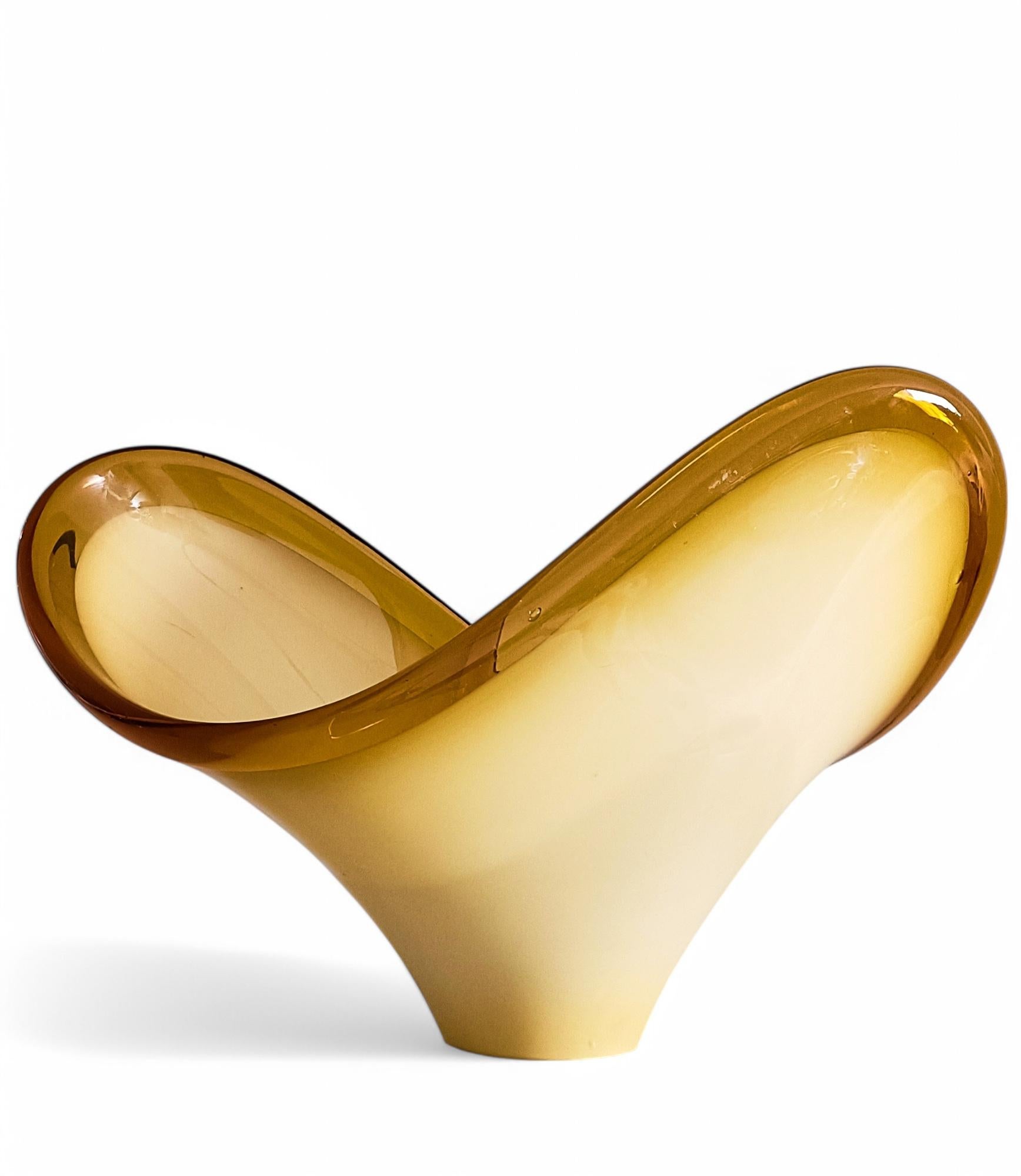 
Mid-Century Modern Hand-Blown Murano Glass Centerpiece – Italy, c. 1950s

Exceptional mid-century Murano glass centerpiece, hand-blown in Italy during the 1950s. This heavy, high-quality piece features a striking opaline butterscotch-colored body,