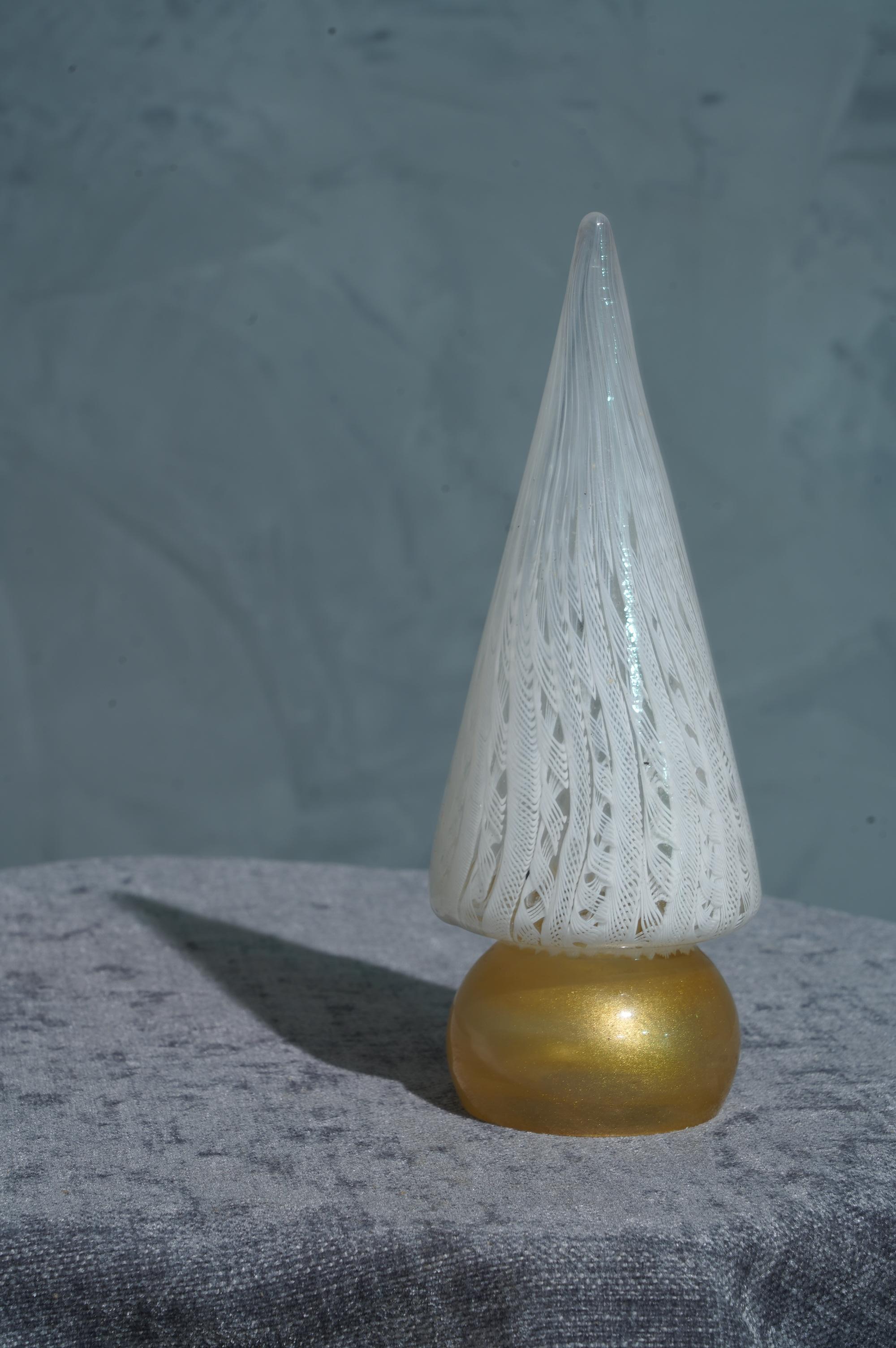Very particular sculpture of Tree in Murano glass, stylized and linear like the art of glass in Venice commands.

The sculpture represents a stylized Christmas tree, with a gold base and a white part of the stem. You can see from the photos the