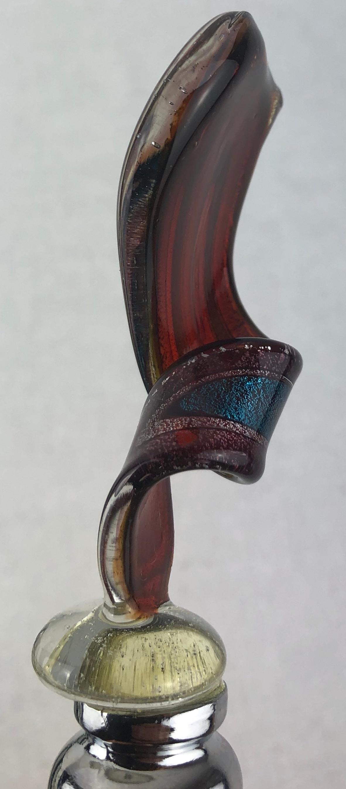 Vintage Murano Glass Bottle Stopper

This charming vintage Murano bottle stopper, crafted from exquisite Murano glass, adds a touch of elegance to your barware collection. The vibrant colors and intricate details showcase the artistry of Venetian