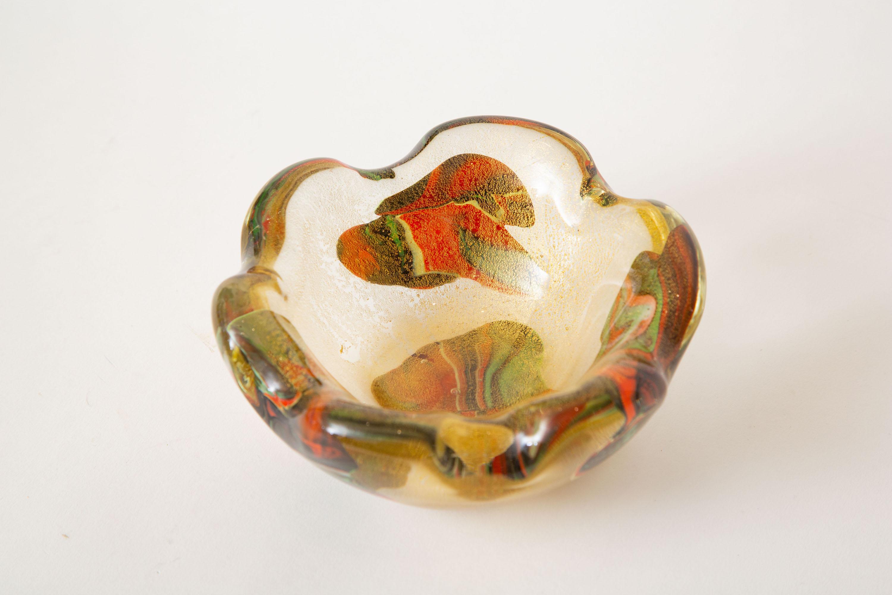 This stunning vintage Italian murano gold glass bowl is by Avem and has random sommerso patchwork blotches or blobs of forms that are in colors of red, orange, gold and green with abundant gold aventurine. It has scalloped edges. This is from the