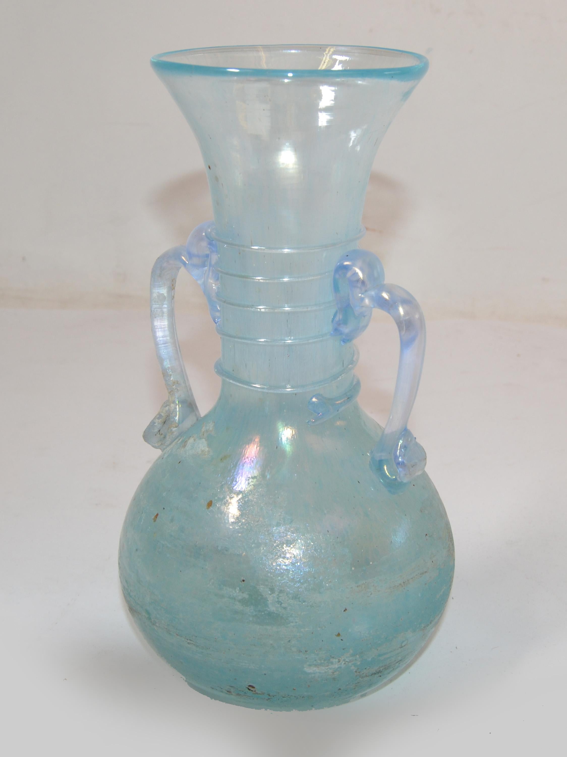 Murano baby blue scavo glass Murano Art glass bud vase, vessel, decanter Mid-Century Modern made in Italy in 1980.
Marked at the base, Made in Murano, Italy.
Measures Handle to Handle: 6 inches.
Opening measures: 3.38 inches.