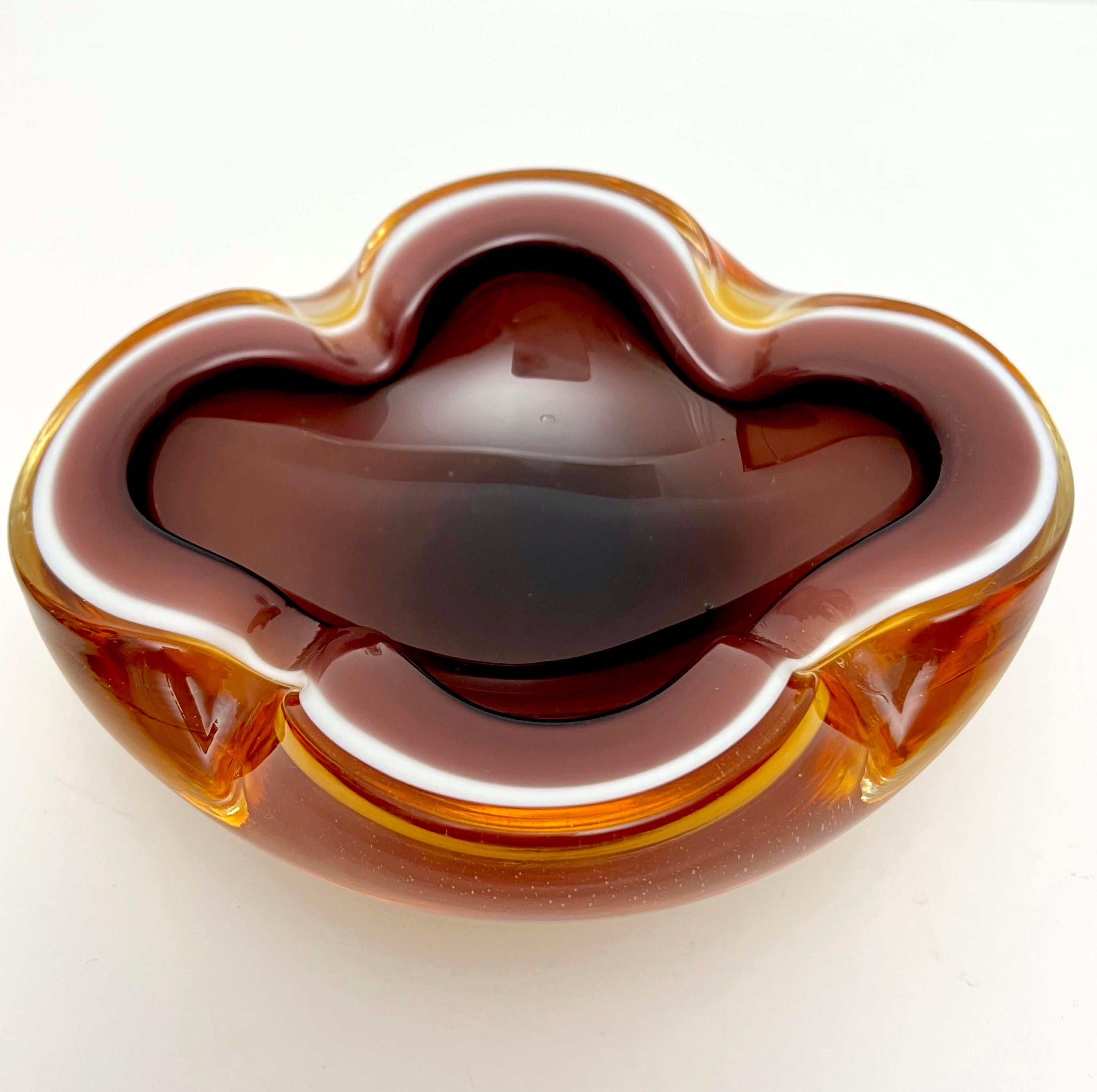 Stunning Geode cased murano bowl, vide poche or cigar ash tray with pinched sides. The three layers of color make this much more unique and rare. Gold on the outside with a thin line of white glass while the inside a warm taupe color giving it the