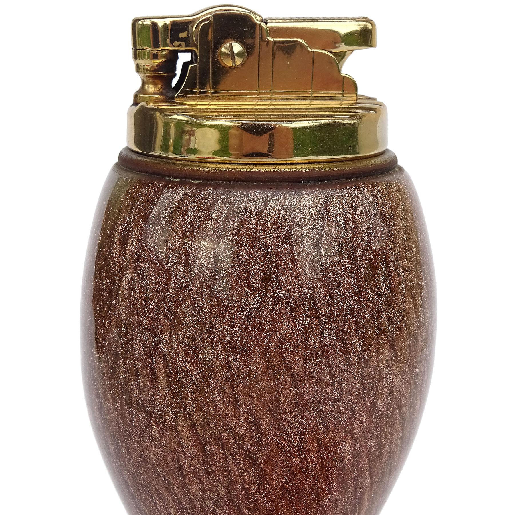 Gorgeous vintage Murano hand blown glittery copper Aventurine flecks Italian art glass corseted pinch waist decorative lighter. Documented to designer Alfredo Barbini. The lighter has a golden / brass color mechanism. It does not spark, but there