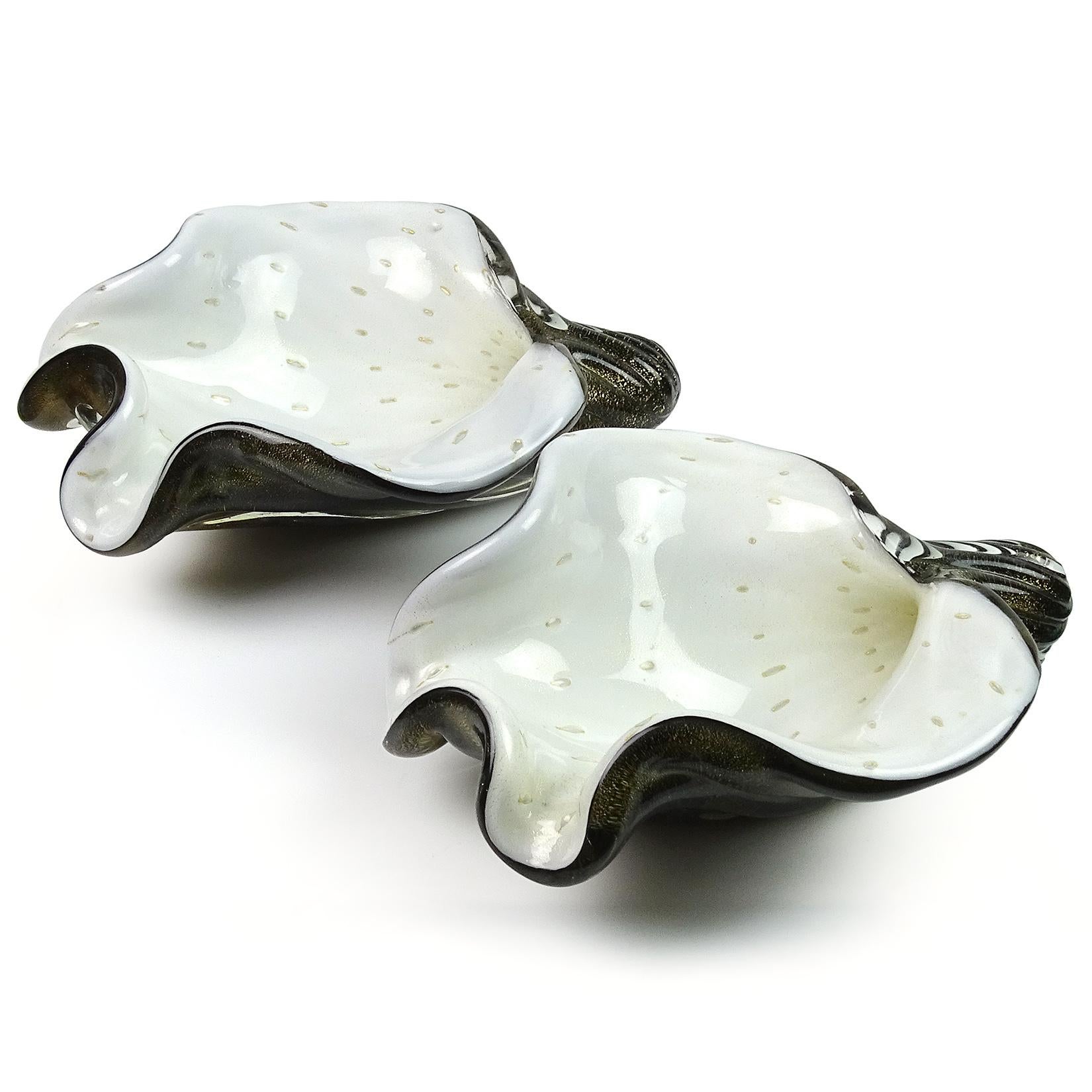 Priced per item (2 available). Beautiful vintage Murano hand blown black, white, controlled bubbles and gold flecks Italian art glass seashell sculptural bowl. Documented to designer Alfredo Barbini, circa 1950s. The design is published in his