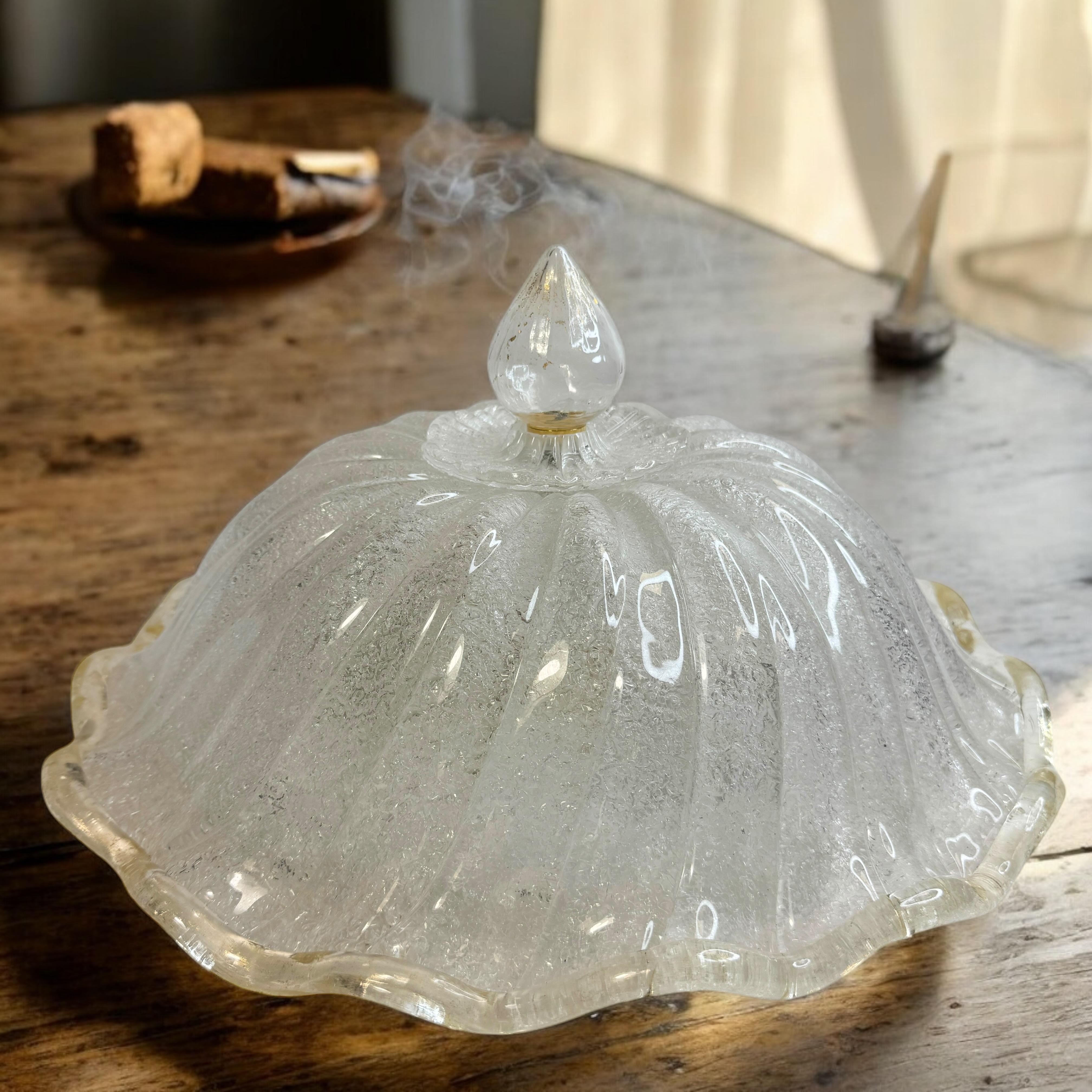 Esta exquisita lámpara de araña empotrada se atribuye al legendario atelier de Barovier & Toso en Italia, hacia la década de 1970. Presenta una pantalla de cristal de Murano soplado a mano, sutilmente cóncava y canalizada, con herrajes metálicos.