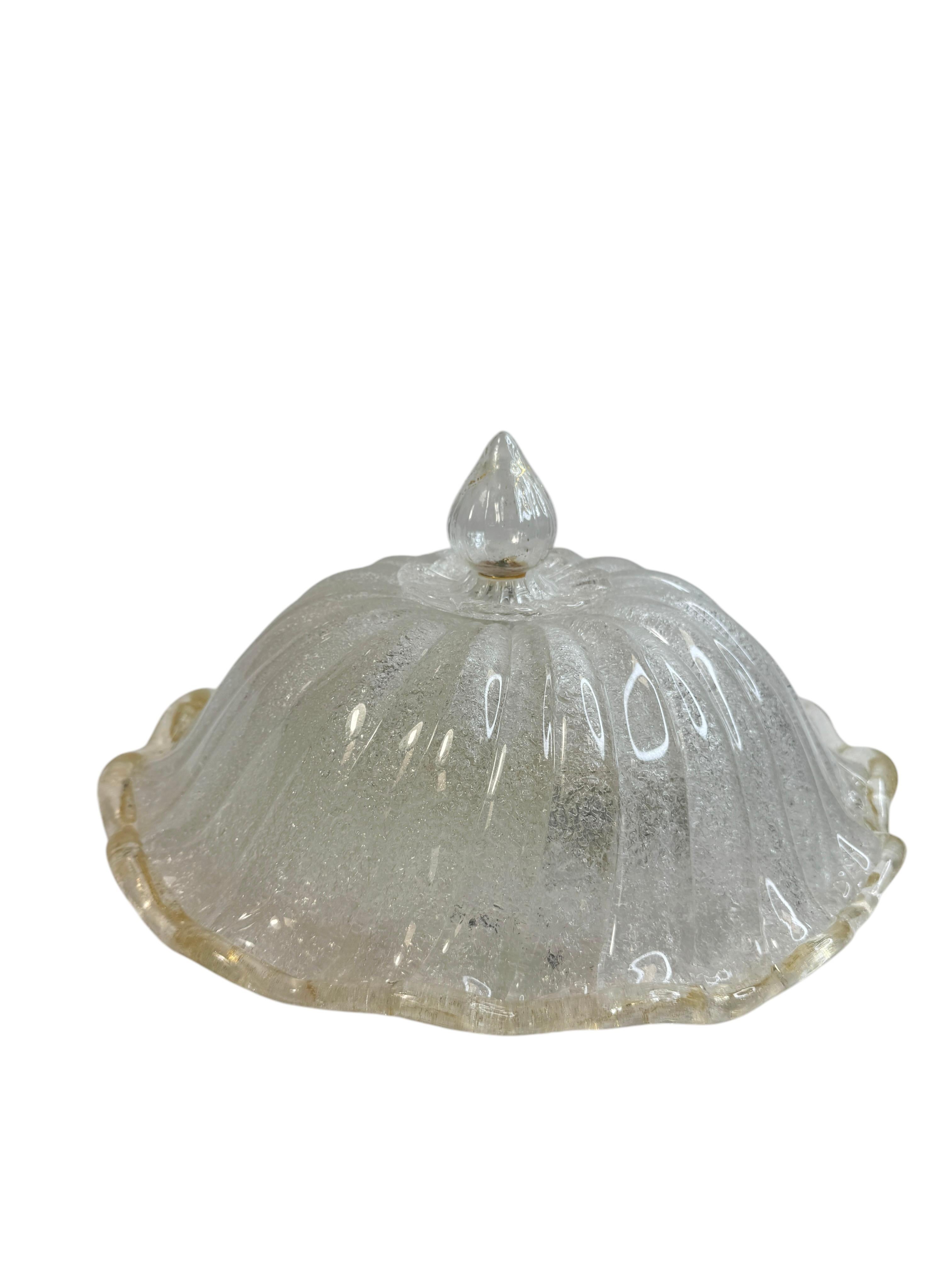 This exquisite flush mount chandelier attributed to the legendary atelier of Barovier & Toso in Italy, circa 1970s. It features a subtly concave and channeled hand blown Murano glass shade with metal fittings. A beautiful hand made gold flake glass