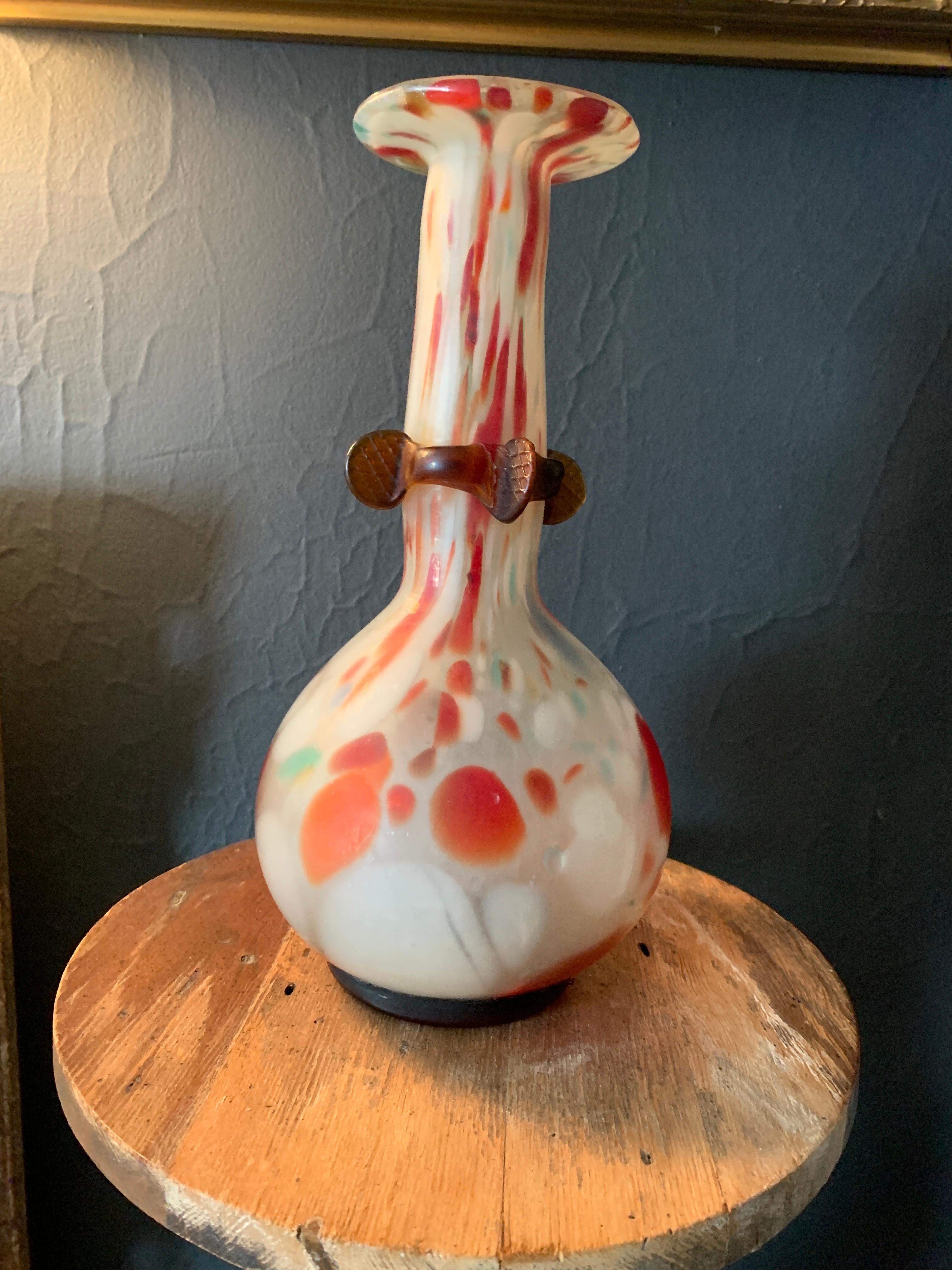 A wonderful long neck vase with several colors melting into each other. A sexy lip at the top with a unique 'stamped' style band or 