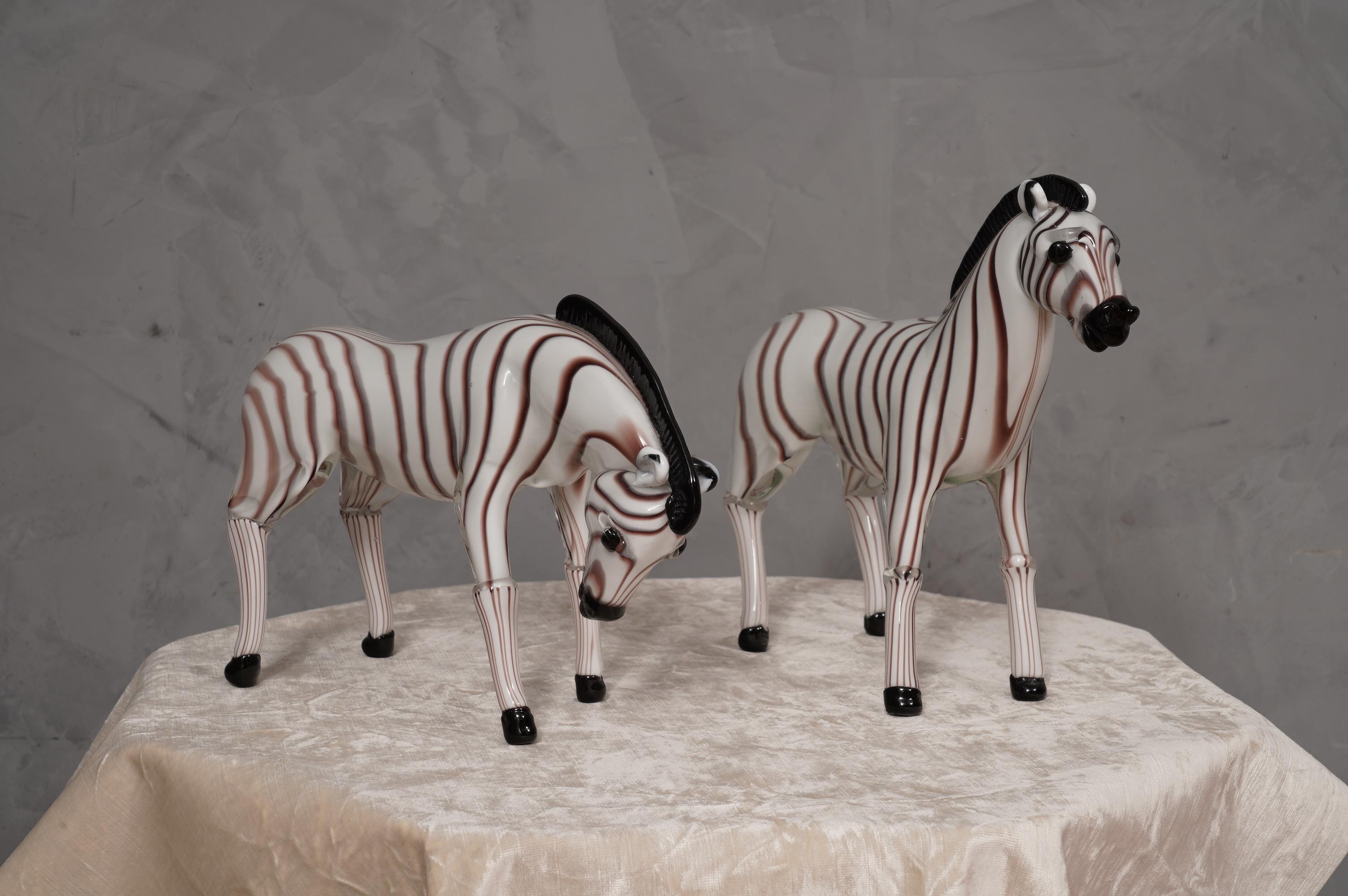 Superb pair of Murano glass sculptures representing two beautiful zebras, unmistakable Murano design. Enchanting to the eye, they require a beautiful illuminated display case.

The two zebras are in Murano glass, white with black streaks. The